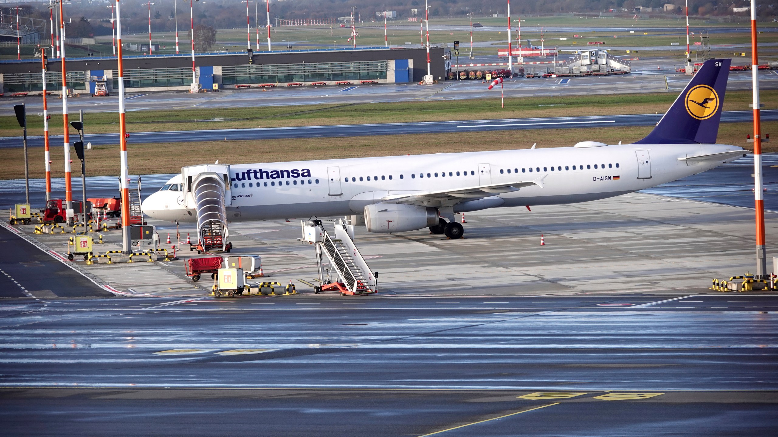 A Lufthansa aircraft stands on the apron at Hamburg Airport, Wednesday, Feb. 7, 2024. Ground staff for Lufthansa walked off the job at five major German airports on Wednesday, causing the airline to cancel hundreds of flights. The Ver.di union called on ground staff at Frankfurt and Munich, Lufthansa's two main hubs, as well as Berlin, Duesseldorf and Hamburg, to strike for 27 hours starting at 4 a.m. Wednesday.(Rabea Gruber/dpa via AP)