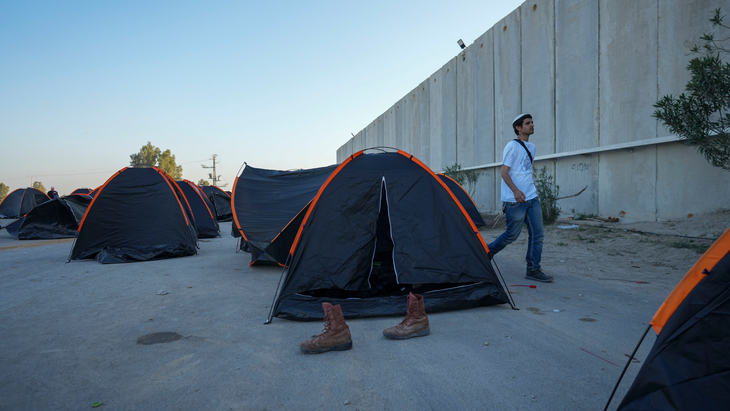 Israeli activists set up tents where they say the spend the night for blocking trucks carrying humanitarian aid into the Gaza Strip at the Kerem Shalom border crossing between Israel and Gaza, in southern Israel, Wednesday, Feb. 7, 2024. The activists say no aid should enter the territory until Israeli hostages held captive by the Hamas militant group are released. (AP Photo/Tsafrir Abayov)