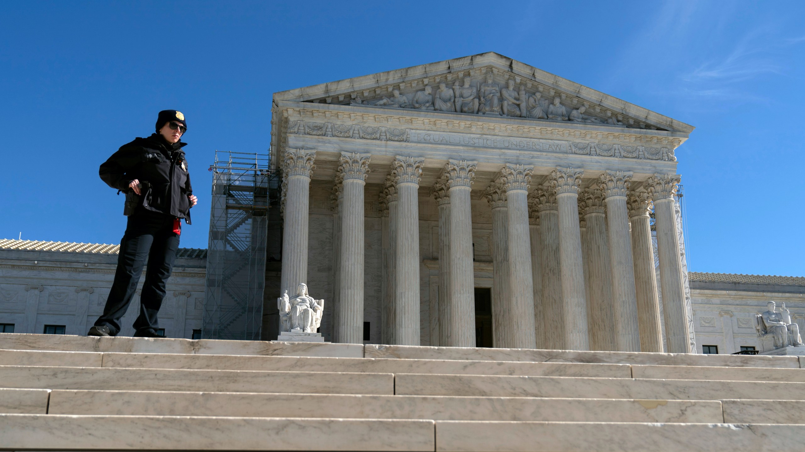 A U.S. Supreme Court police officer stands in fron of the U.S. Supreme Court Wednesday, Feb. 7, 2024, in Washington. The Supreme Court hears arguments on Feb. 8 over whether former President Donald Trump can be kept off the ballot because of his efforts to overturn the 2020 election results, culminating in the Jan. 6, 2021 attack on the Capitol. (AP Photo/Jose Luis Magana)