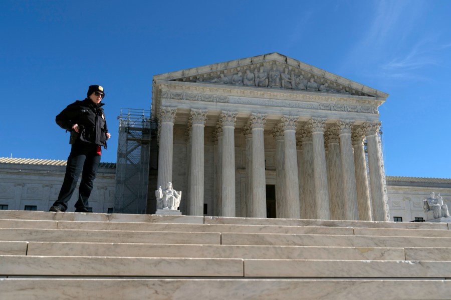 A U.S. Supreme Court police officer stands in fron of the U.S. Supreme Court Wednesday, Feb. 7, 2024, in Washington. The Supreme Court hears arguments on Feb. 8 over whether former President Donald Trump can be kept off the ballot because of his efforts to overturn the 2020 election results, culminating in the Jan. 6, 2021 attack on the Capitol. (AP Photo/Jose Luis Magana)