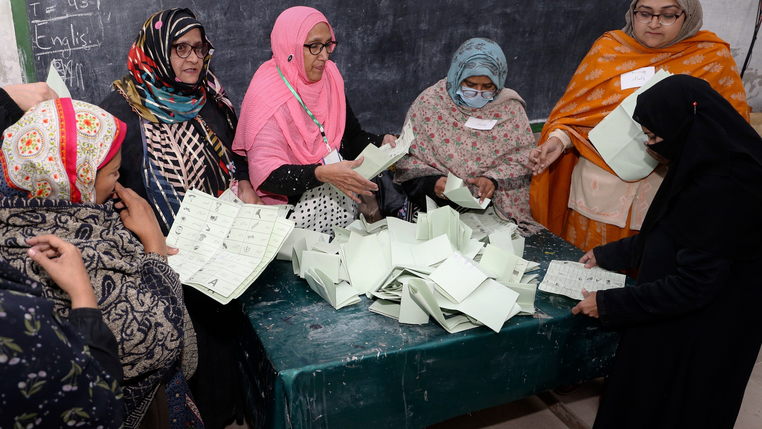 Members of polling staff start counting the votes following polls closed for parliamentary elections, in Islamabad, Pakistan, Thursday, Feb. 8, 2024. (AP Photo/Pervez Masih)