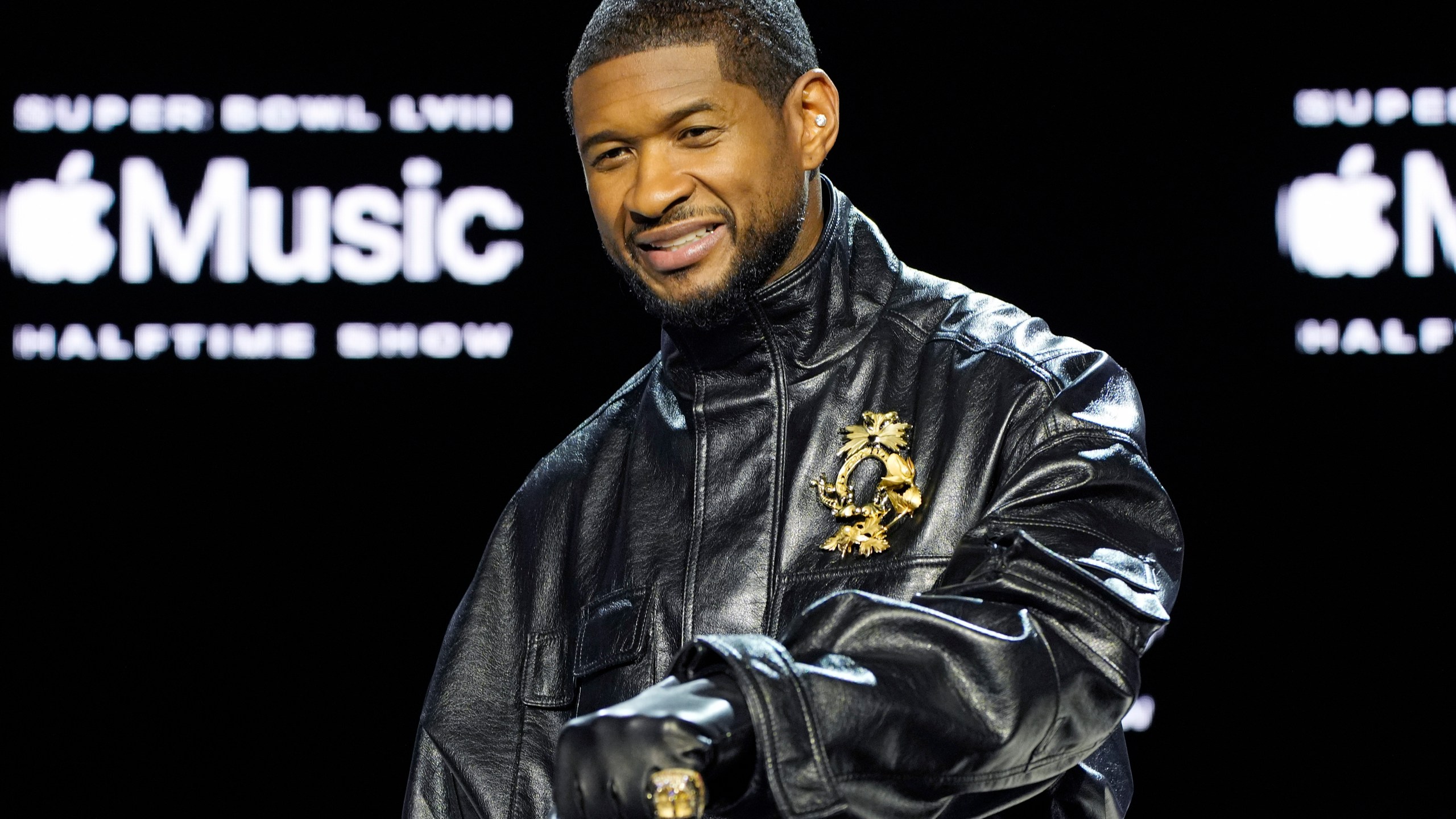 Usher poses for photographers during a news conference ahead of the Super Bowl 58 NFL football game Thursday, Feb. 8, 2024, in Las Vegas. Usher will perform during the Super Bowl halftime show. (AP Photo/John Locher)