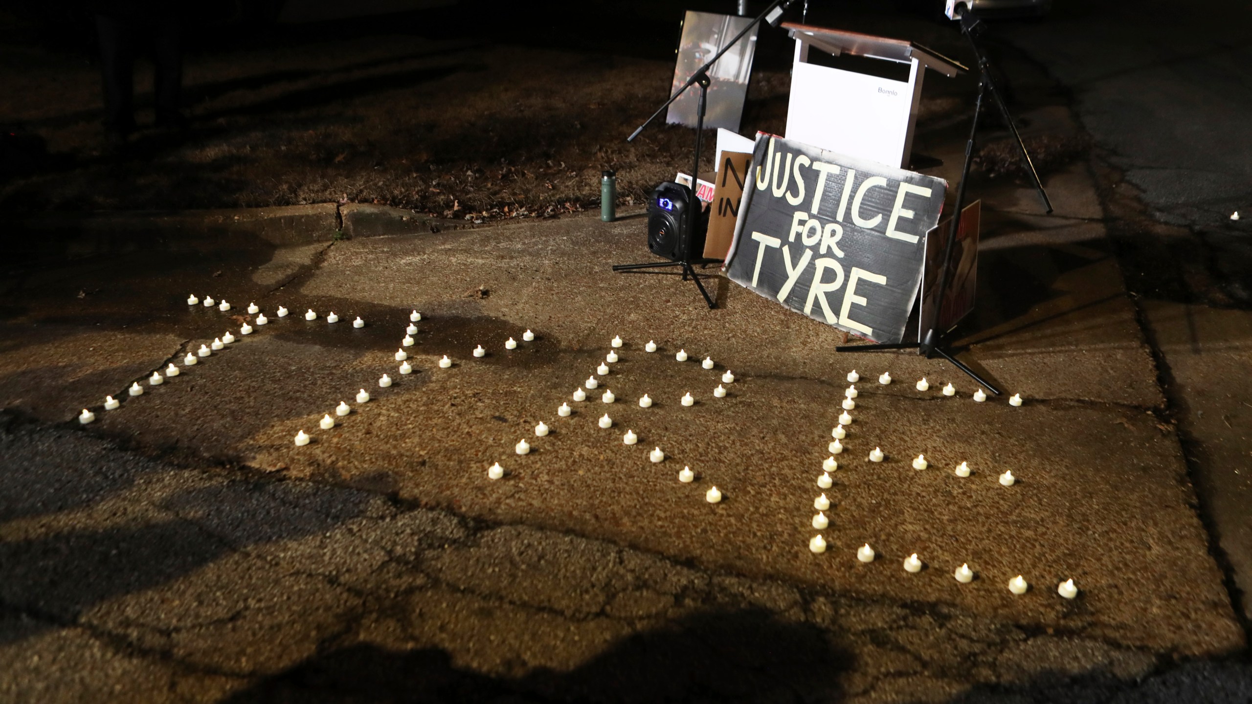 FILE - Candles spell out the name of Tyre Nichols during a candlelight vigil for Nichols on the anniversary of his death, Jan. 7, 2024, in Memphis, Tenn. A judge on Thursday, Feb. 8, 2024, pushed back for four months the federal court trial of four former Memphis police officers charged with civil rights violations in the beating death of Nichols. (AP Photo/Karen Pulfer Focht, file)