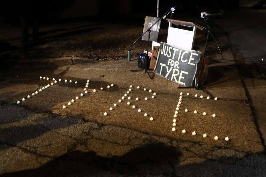 FILE - Candles spell out the name of Tyre Nichols during a candlelight vigil for Nichols on the anniversary of his death, Jan. 7, 2024, in Memphis, Tenn. A judge on Thursday, Feb. 8, 2024, pushed back for four months the federal court trial of four former Memphis police officers charged with civil rights violations in the beating death of Nichols. (AP Photo/Karen Pulfer Focht, file)