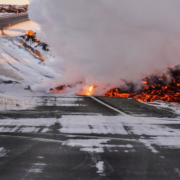 Lava spills onto the road to Grindavík, close to the exit for the Blue Lagoon, in Grindavík, Iceland, Thursday, Feb. 8, 2024. A volcano in southwestern Iceland has erupted for the third time since December and sent jets of lava into the sky. The eruption on Thursday morning triggered the evacuation the Blue Lagoon spa which is one of the island nation’s biggest tourist attractions. (AP Photo/Marco Di Marco)
