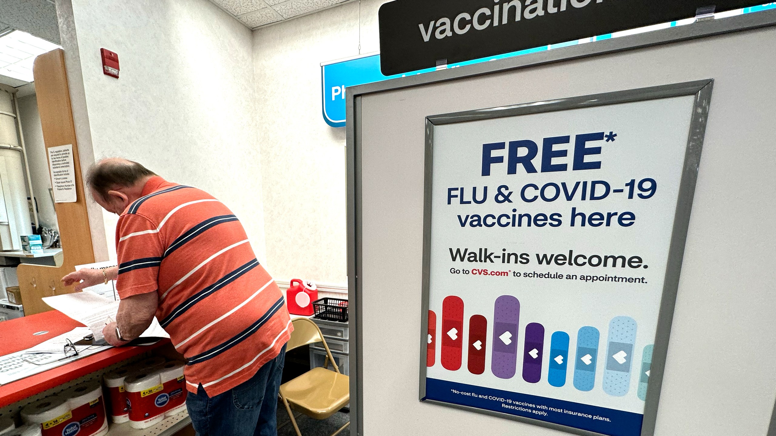 FILE - A sign for flu and covid vaccinations is displayed at a pharmacy store in Palatine, Ill., Wednesday, Sept. 13, 2023. The flu is hanging on in the U.S., intensifying in some areas of the country after weeks of apparent decline., according to data released by the U.S. Centers for Disease Control and Prevention on Friday, Feb. 9, 2024. (AP Photo/Nam Y. Huh, File)