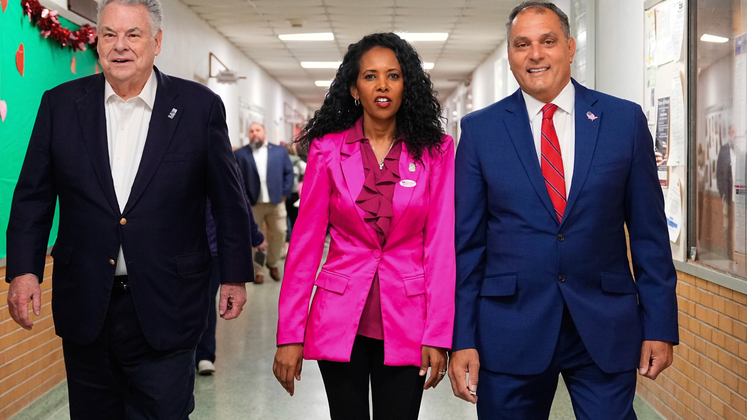 CORRECTS LAST NAME TO PILIP, NOT PHILIP - Mazi Pilip, center, the Republican congressional candidate for New York's 3rd district, arrives to vote early at a polling station in Massapequa, N.Y., Friday, Feb. 9, 2024. The race to replace disgraced former Rep. George Santos pits Pilip, a Nassau County legislator, against former U.S. Rep. Tom Suozzi, a Democrat who represented the district for three terms before quitting to run for governor. Joining Pilip are, former U.S Rep. Peter King, left, and Oyster Bay, N.Y., Town Supervisor Joseph Saladino. (Adam Gray/Pool Photo via AP)