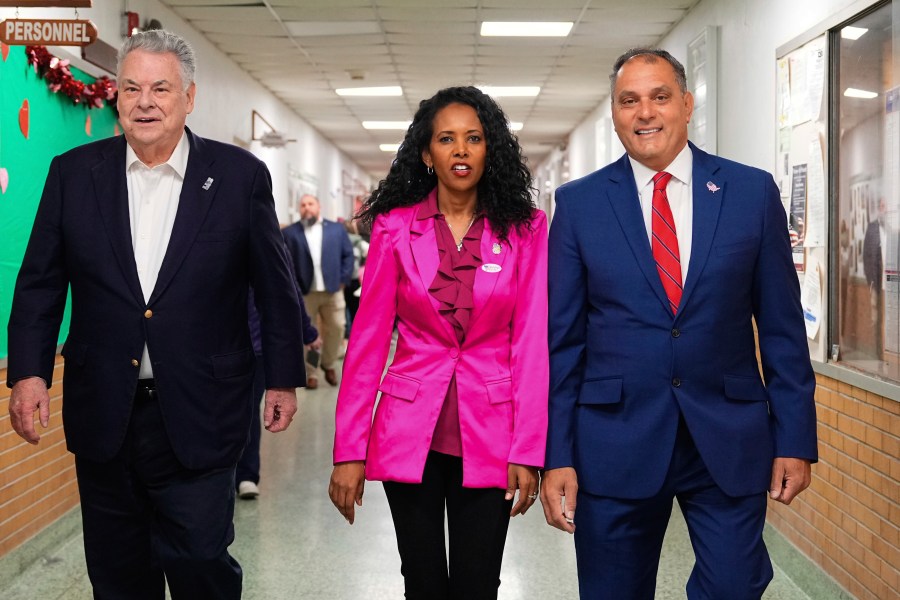 CORRECTS LAST NAME TO PILIP, NOT PHILIP - Mazi Pilip, center, the Republican congressional candidate for New York's 3rd district, arrives to vote early at a polling station in Massapequa, N.Y., Friday, Feb. 9, 2024. The race to replace disgraced former Rep. George Santos pits Pilip, a Nassau County legislator, against former U.S. Rep. Tom Suozzi, a Democrat who represented the district for three terms before quitting to run for governor. Joining Pilip are, former U.S Rep. Peter King, left, and Oyster Bay, N.Y., Town Supervisor Joseph Saladino. (Adam Gray/Pool Photo via AP)