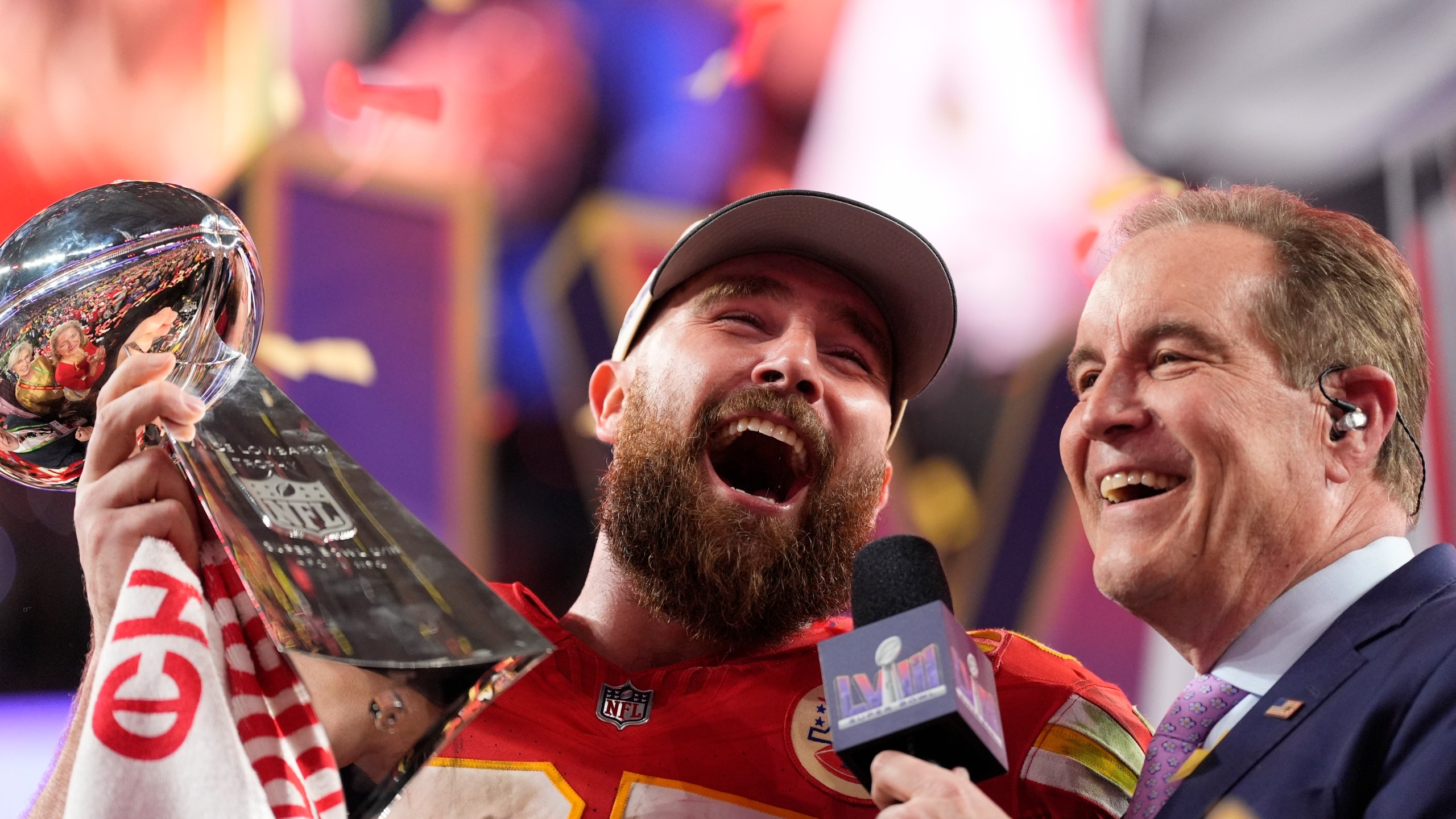 Kansas City Chiefs tight end Travis Kelce (87) celebrates while holding the Vince Lombardi Trophy after the NFL Super Bowl 58 football game against the San Francisco 49ers, Sunday, Feb. 11, 2024, in Las Vegas. The Chiefs won 25-22. (AP Photo/Ashley Landis)