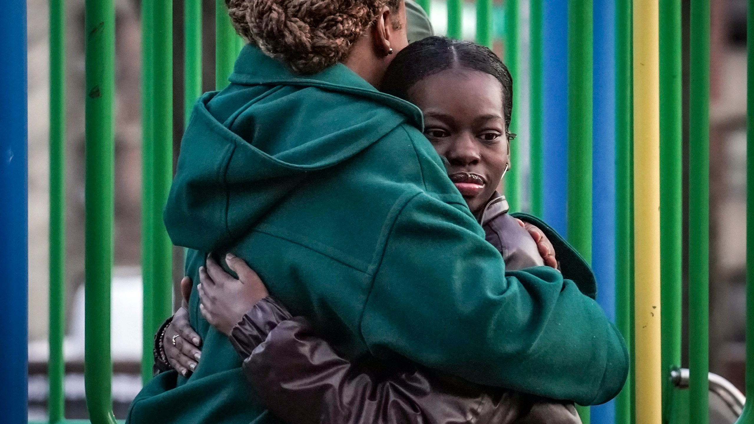 Derry Oliver, 17, right, hugs her mother, also Derry Oliver, during a visit to a playground near home, Friday, Feb. 9, 2024, in New York. During the COVID-19 pandemic, the younger Oliver embraced therapy as she struggled with the isolation of remote learning, even as her mother pushed back. (AP Photo/Bebeto Matthews)