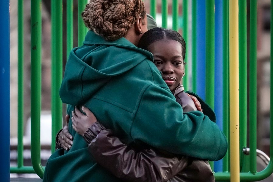 Derry Oliver, 17, right, hugs her mother, also Derry Oliver, during a visit to a playground near home, Friday, Feb. 9, 2024, in New York. During the COVID-19 pandemic, the younger Oliver embraced therapy as she struggled with the isolation of remote learning, even as her mother pushed back. (AP Photo/Bebeto Matthews)