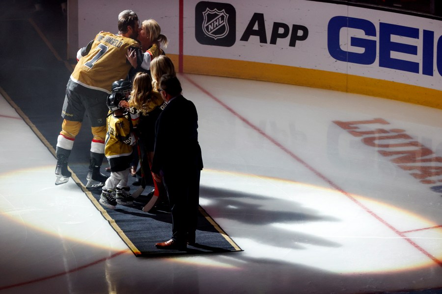 Vegas Golden Knights defenseman Alex Pietrangelo (7) kisses his wife, Jayne, during a ceremony honoring his 1000th NHL game prior to an NHL hockey game against the Minnesota Wild, Monday, Feb. 12, 2024, in Las Vegas. (AP Photo/Ian Maule)