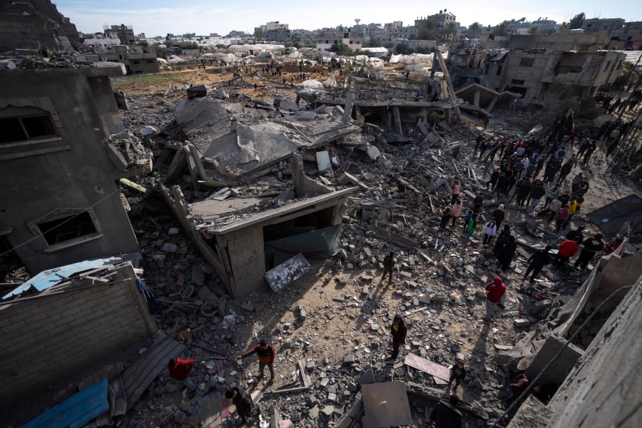 Palestinians inspect the damage to residential buildings where two Israeli hostages were reportedly held before being rescued during an operation by Israeli security forces in Rafah, southern Gaza Strip, Monday, Feb. 12, 2024. The Israeli military said early Monday that it had rescued the two hostages from captivity in the Gaza Strip. The operation, which was accompanied by airstrikes, killed dozens of Palestinians, according to local health officials. (AP Photo/Fatima Shbair)