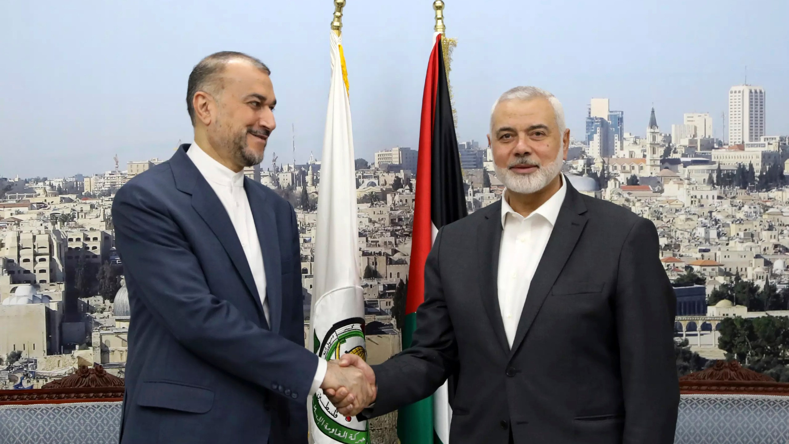 In this picture released by the Iranian Foreign Ministry, Iran's Foreign Minister Hossein Amirabdollahian, left, shakes hands with Hamas chief Ismail Haniyeh during their meeting in Doha, Qatar, Tuesday, Feb. 13, 2024. (Iranian Foreign Ministry via AP)