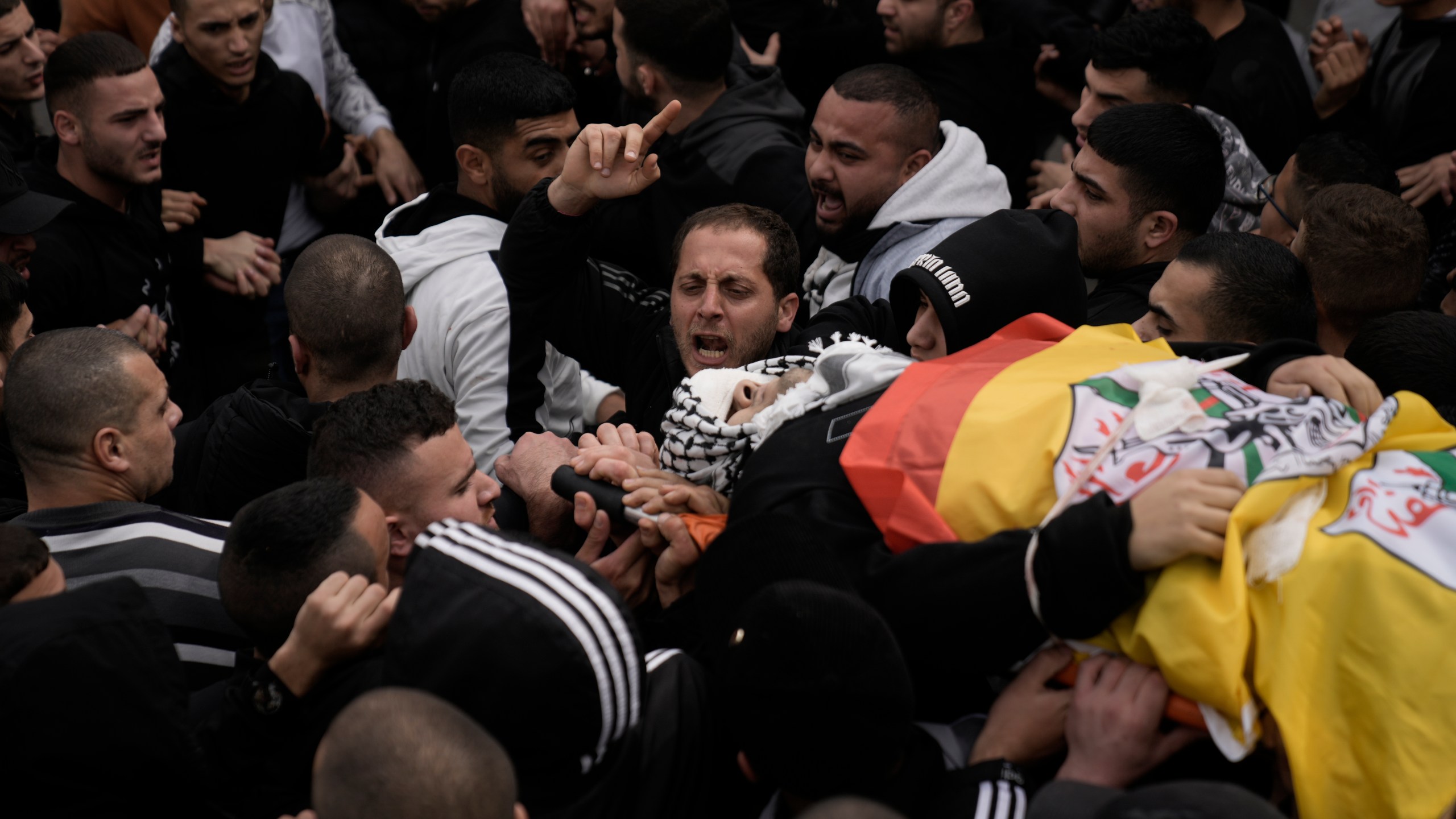 Palestinians attend the funeral of Mohammed Sherif Hassan Selmi in Qalqiliya, West Bank, Tuesday, Feb. 13, 2024. The Israeli army said that Salemi was shot and killed when he tried to overrun soldiers. (AP Photo/Majdi Mohammed)