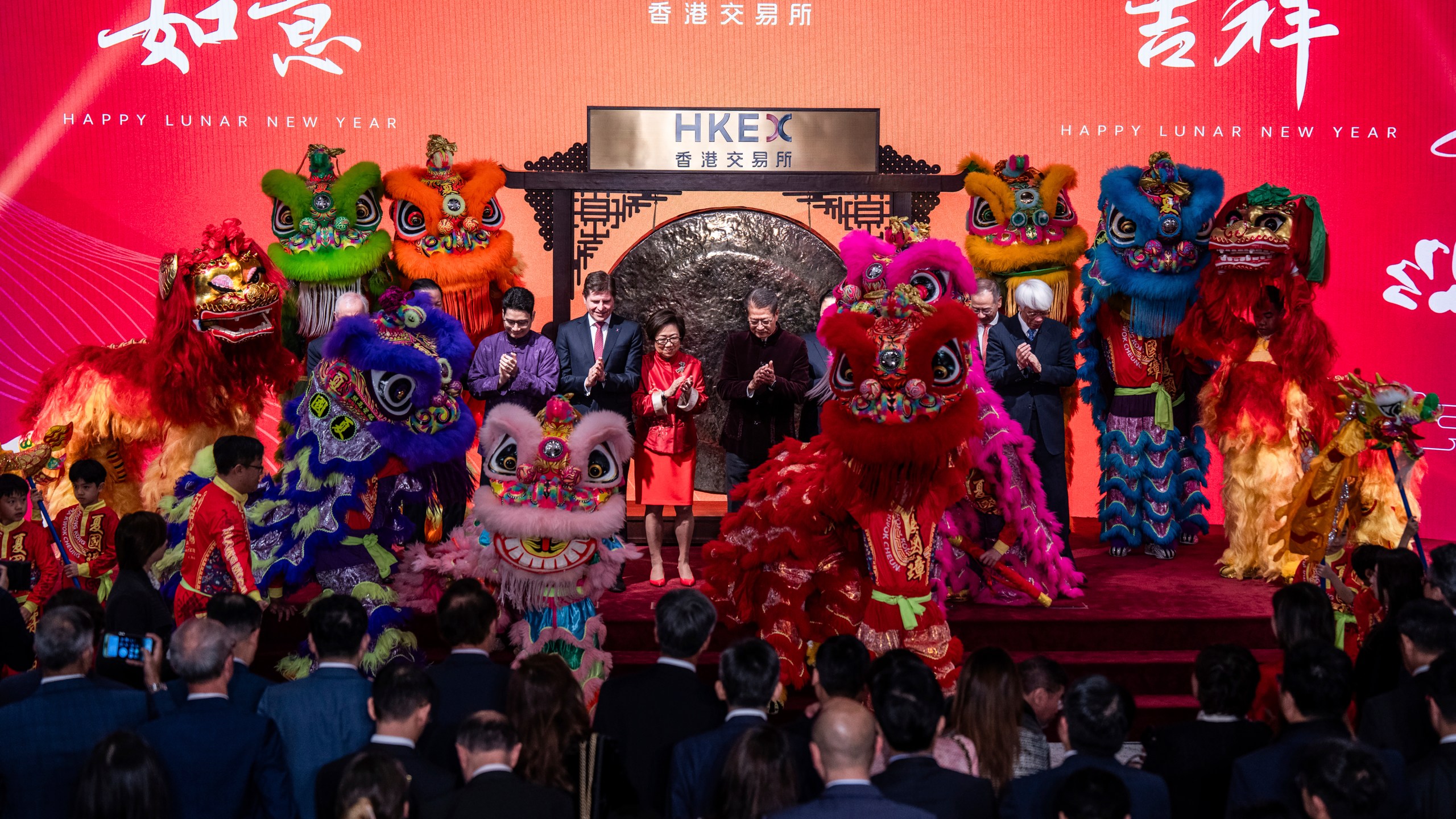Hong Kong Financial Secretary Paul Chan, center right, and Chairperson of Hong Kong Stock Exchange Laura M Cha, center left, attend a ceremony to mark the first trading day of the Year of the Dragon at the Hong Kong Exchanges (HKEX) in Hong Kong, Wednesday, Feb. 14, 2024. (AP Photo/Louise Delmotte)