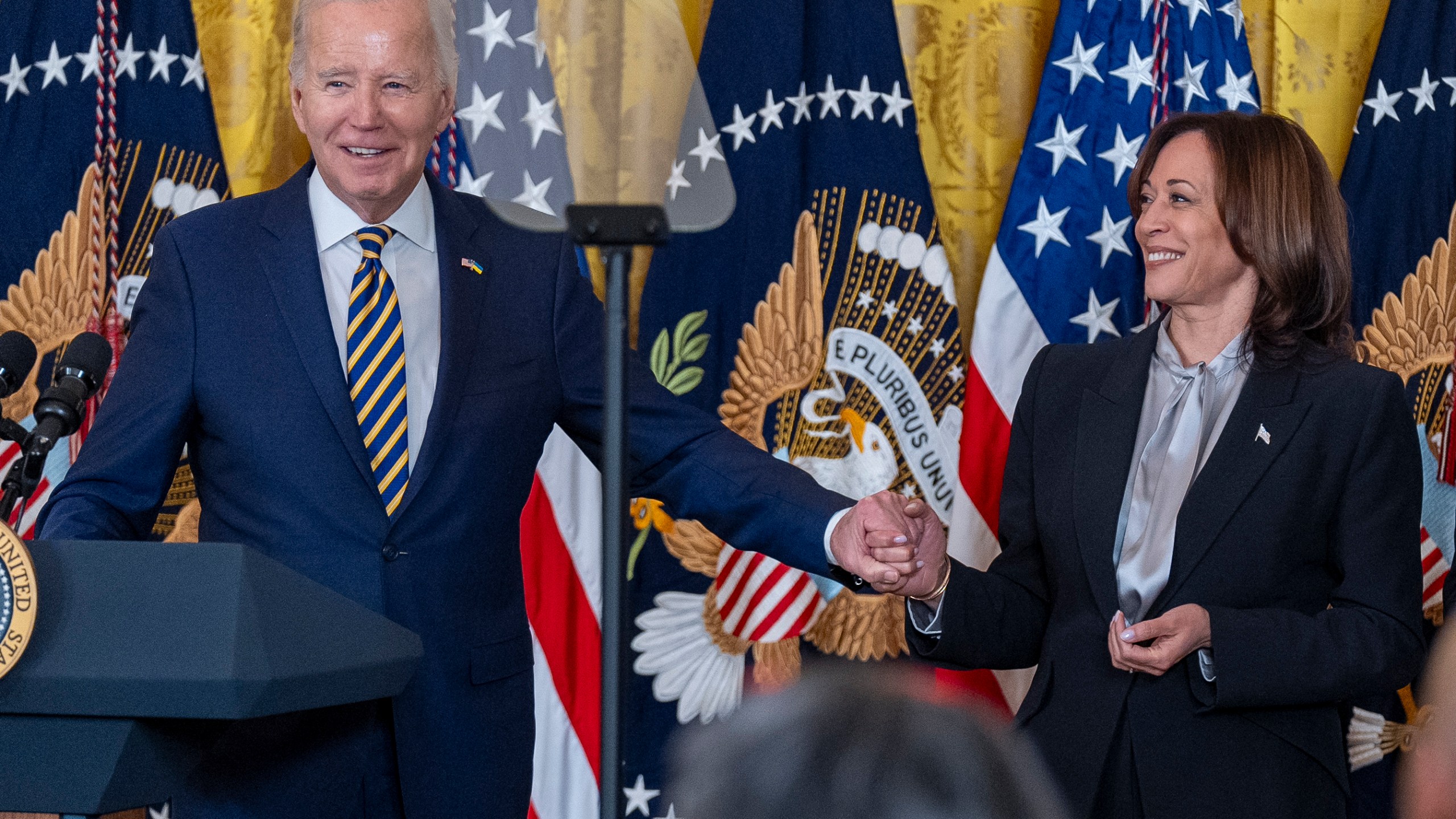 President Joe Biden, holds hands with Vice President Kamala Harris as he speaks at a reception in recognition of Black History Month in the East Room of the White House in Washington, Tuesday, Feb. 6, 2024. (AP Photo/Andrew Harnik)