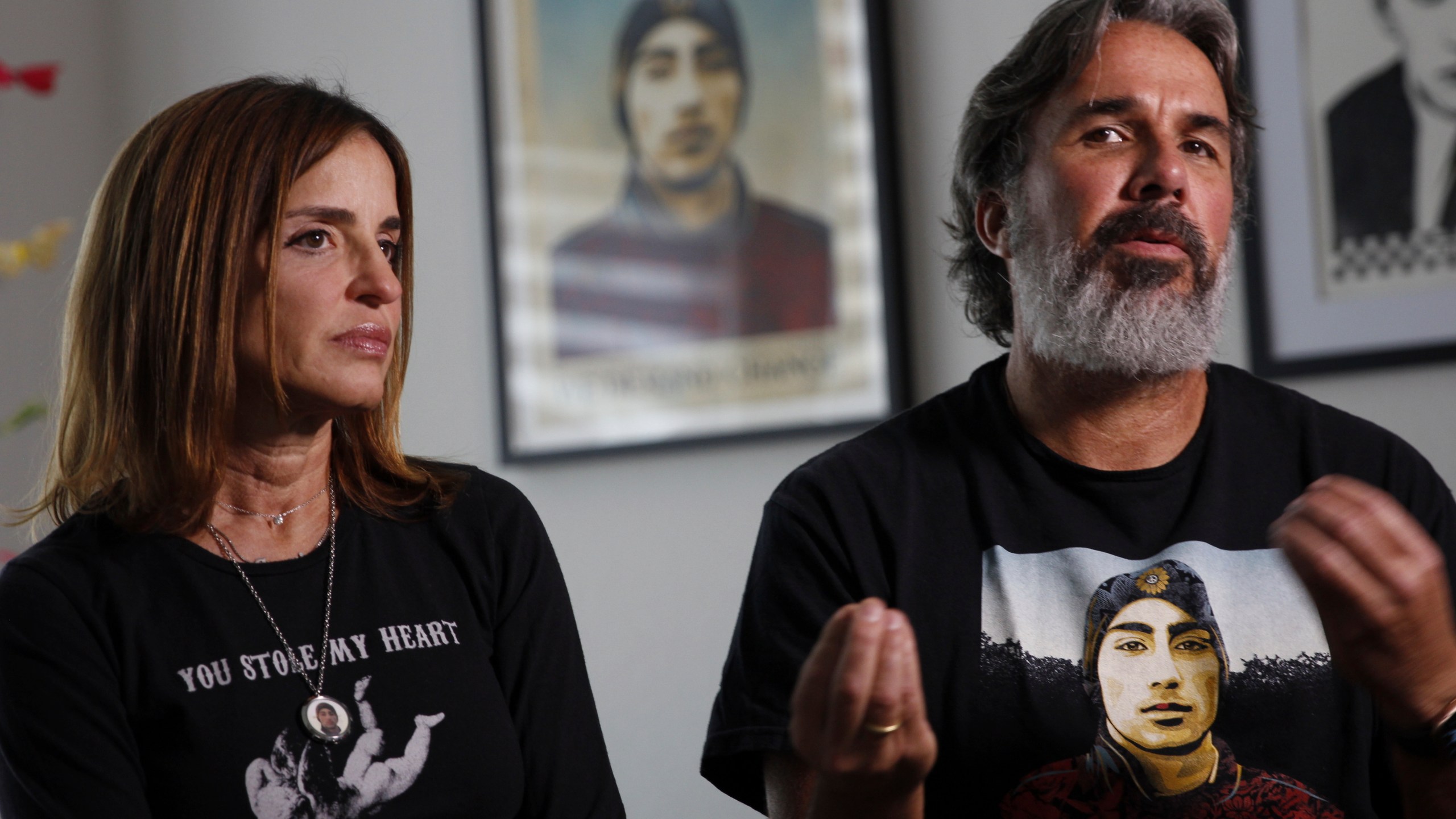 Manuel and Patricia Oliver, the parents of Joaquin Oliver, one of the victims of the 2018 mass shooting at Marjory Stoneman Douglas High School in Parkland, Fla., sit for an interview in Coral Springs, Fla., on Friday Feb. 9, 2024. The Olivers are launching a campaign where re-created voices of gun violence victims will call federal lawmakers. The recordings re-creating voices of victims from around the country are being robocalled to U.S. senators and House members who oppose stricter gun laws. (AP Photo/Cody Jackson)