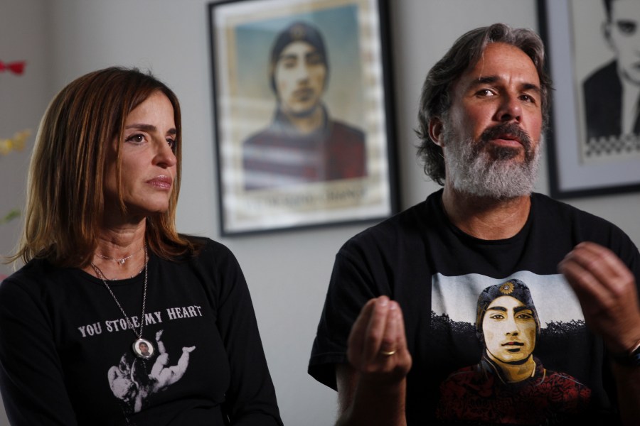 Manuel and Patricia Oliver, the parents of Joaquin Oliver, one of the victims of the 2018 mass shooting at Marjory Stoneman Douglas High School in Parkland, Fla., sit for an interview in Coral Springs, Fla., on Friday Feb. 9, 2024. The Olivers are launching a campaign where re-created voices of gun violence victims will call federal lawmakers. The recordings re-creating voices of victims from around the country are being robocalled to U.S. senators and House members who oppose stricter gun laws. (AP Photo/Cody Jackson)