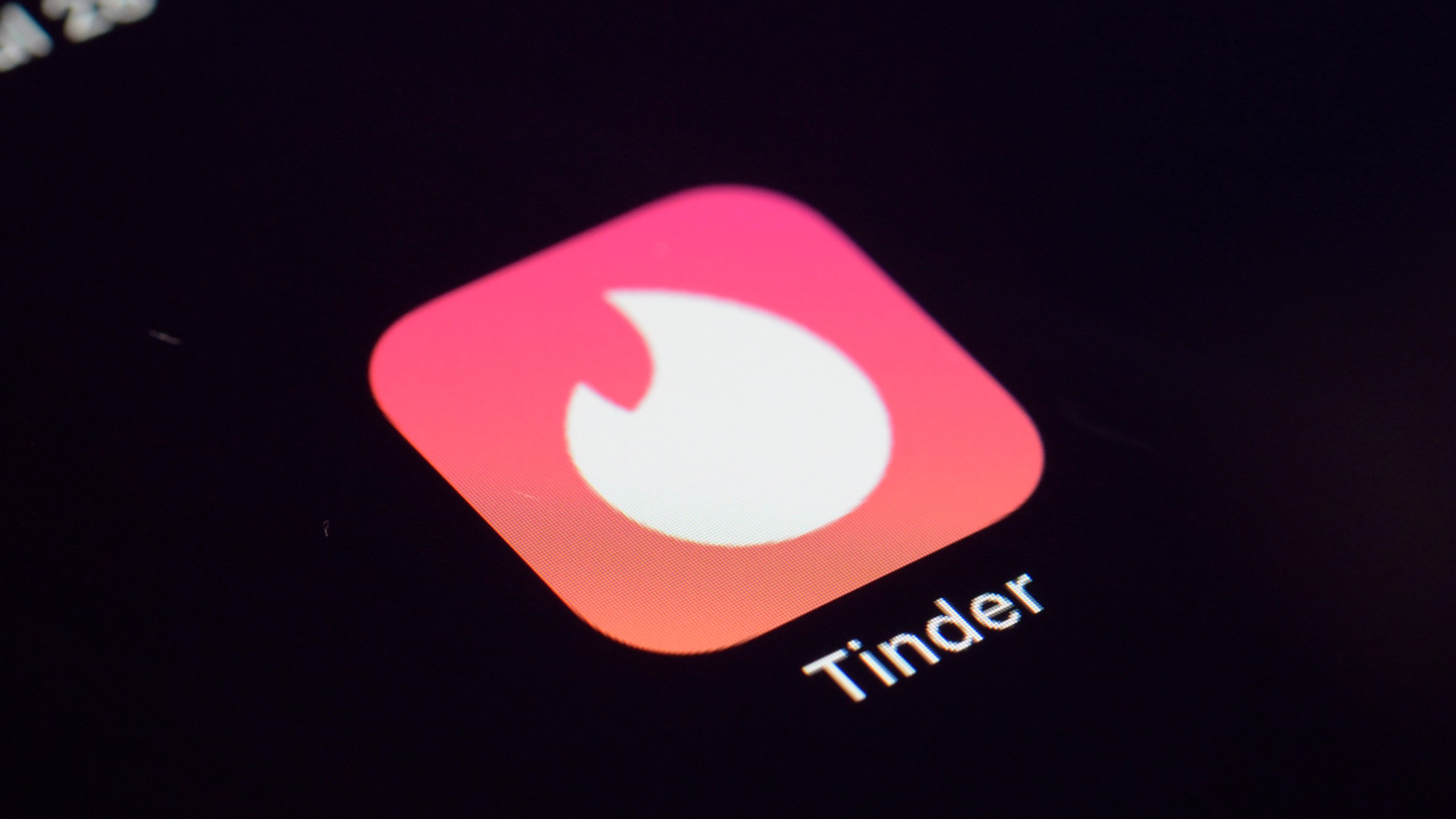 FILE - The icon for the dating app Tinder appears on a device, July 28, 2020, in New York. Tinder, Hinge and other dating apps are designed with addictive features that encourage “compulsive” use, a proposed class action lawsuit against parent company Match Group claims. The lawsuit filed Wednesday, Feb. 14, 2024, says Match intentionally designs its dating platforms with game-like features that “lock users into a perpetual pay-to-play loop” prioritizing profit over promises to help users find relationships. (AP Photo/Patrick Sison, File)