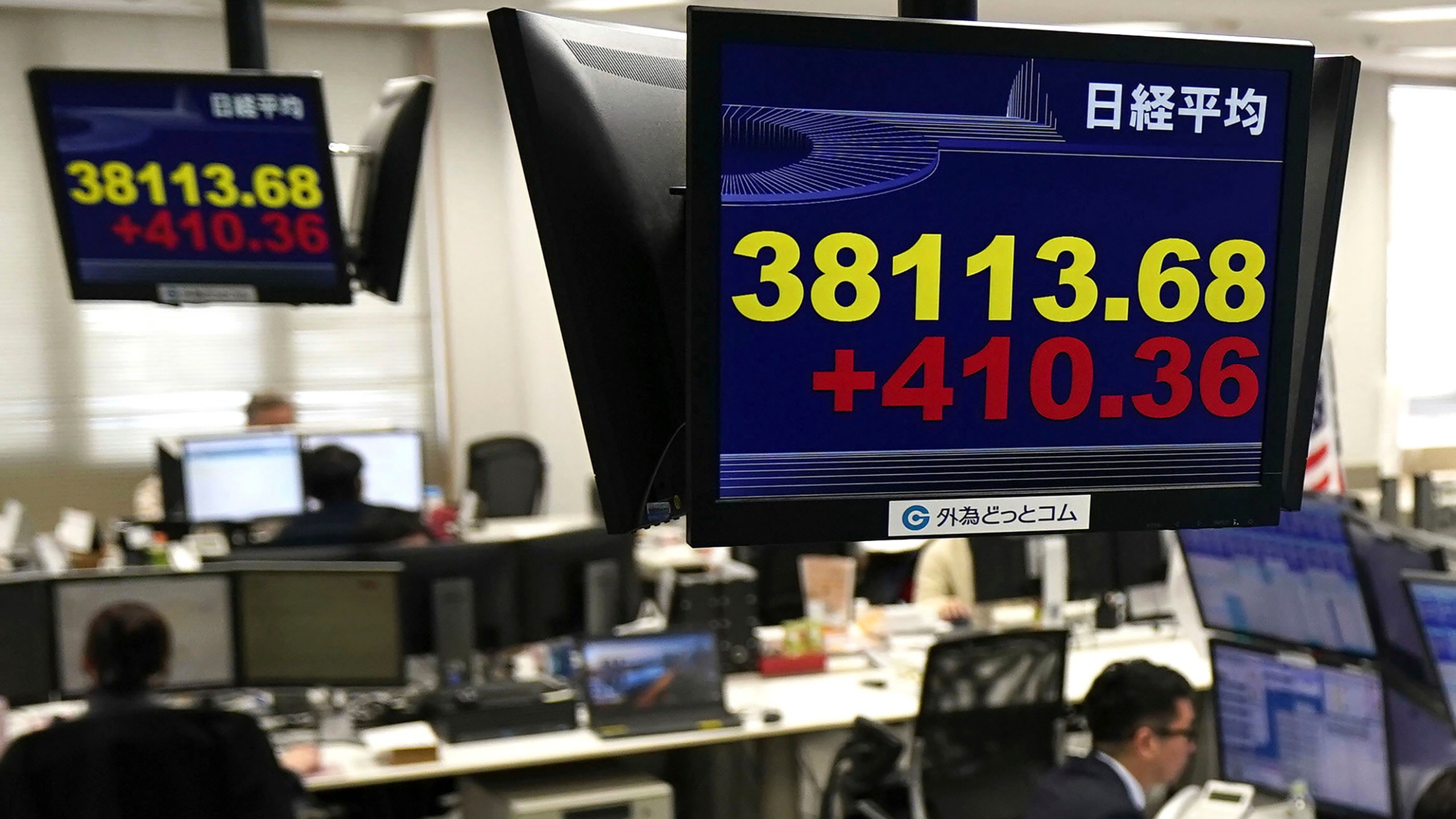 Monitors show Nikkei stock index, yellow, at a foreign exchange trader's company in Tokyo, Thursday, Feb. 15, 2024. Shares rose in Asia on Thursday after Wall Street stocks recovered much of their sharp losses from a day before.(Kyodo News via AP)