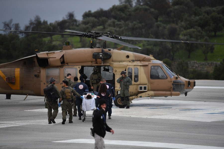 An Israeli medical team evacuate a person injured by a rocket fired from Lebanon, at Ziv hospital in Safed, northern Israel, Wednesday, Feb. 14, 2024. Israeli media reported 1 killed and eight wounded in the rocket attack. The town, which is around 12 kilometers (7 miles) from the border is farther south than most of the daily border skirmishes with Lebanon's Hezbollah militant group. (AP Photo/Gil Eliyahu)