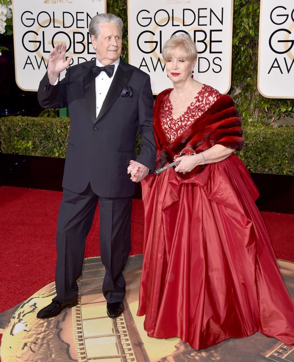 FILE - Brian Wilson, left, and his wife Melinda Ledbetter arrive at the 73rd annual Golden Globe Awards in Beverly Hills, Calif., on Jan. 10, 2016. The management team of the Beach Boys co-founder has filed papers to put him in a conservatorship. The court filing says Wilson needs someone to oversee his daily life and medical decisions because of the recent death of his wife. (Photo by Jordan Strauss/Invision/AP, File)