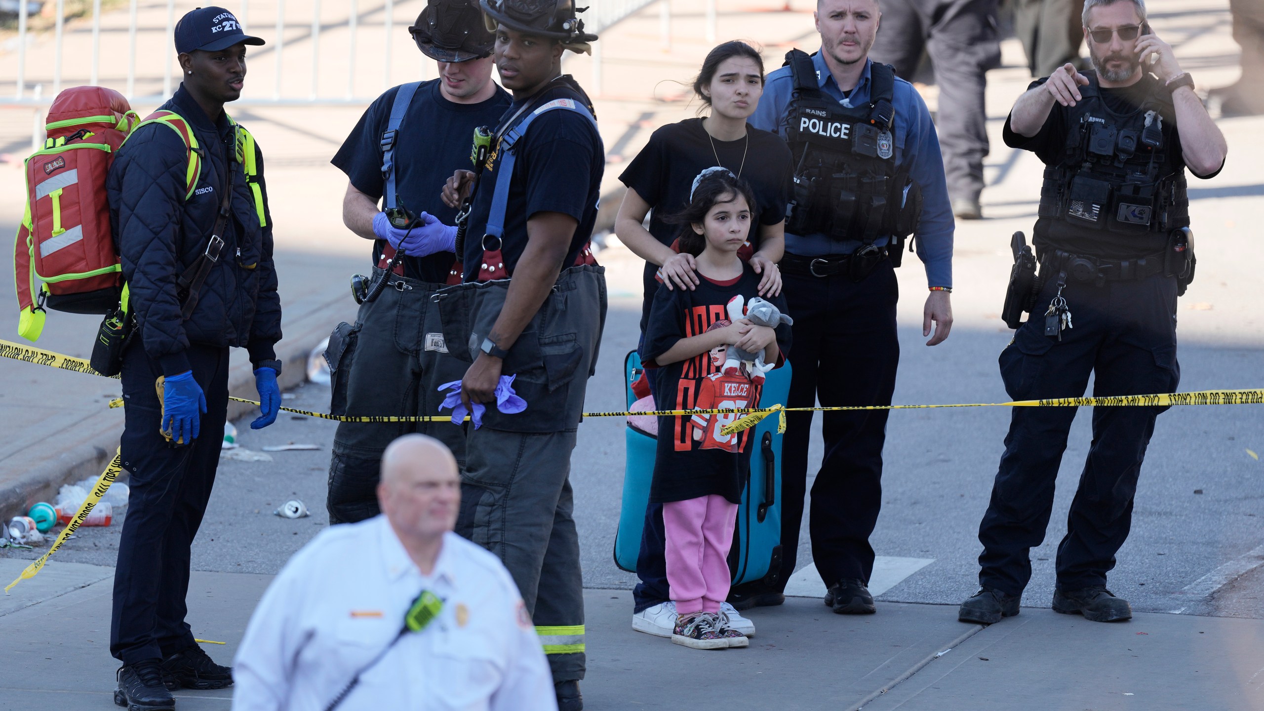 Emergency worker direct people leaving a victory rally celebrating the Kansas City Chiefs Super Bowl 58 win after a shooting following the event Wednesday, Feb. 14, 2024, at Union Station in Kansas City. Mo. (AP Photo/Charlie Riedel)