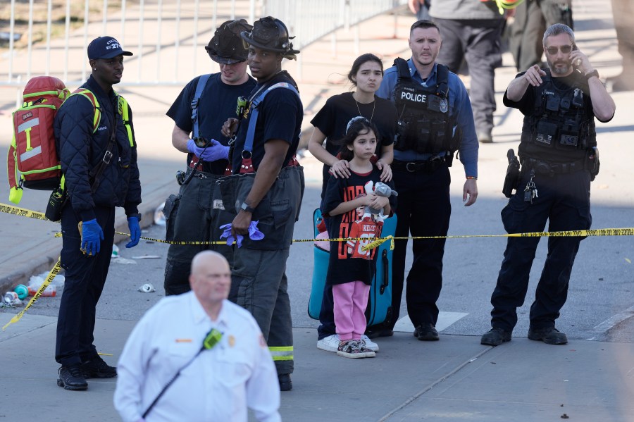 Emergency worker direct people leaving a victory rally celebrating the Kansas City Chiefs Super Bowl 58 win after a shooting following the event Wednesday, Feb. 14, 2024, at Union Station in Kansas City. Mo. (AP Photo/Charlie Riedel)