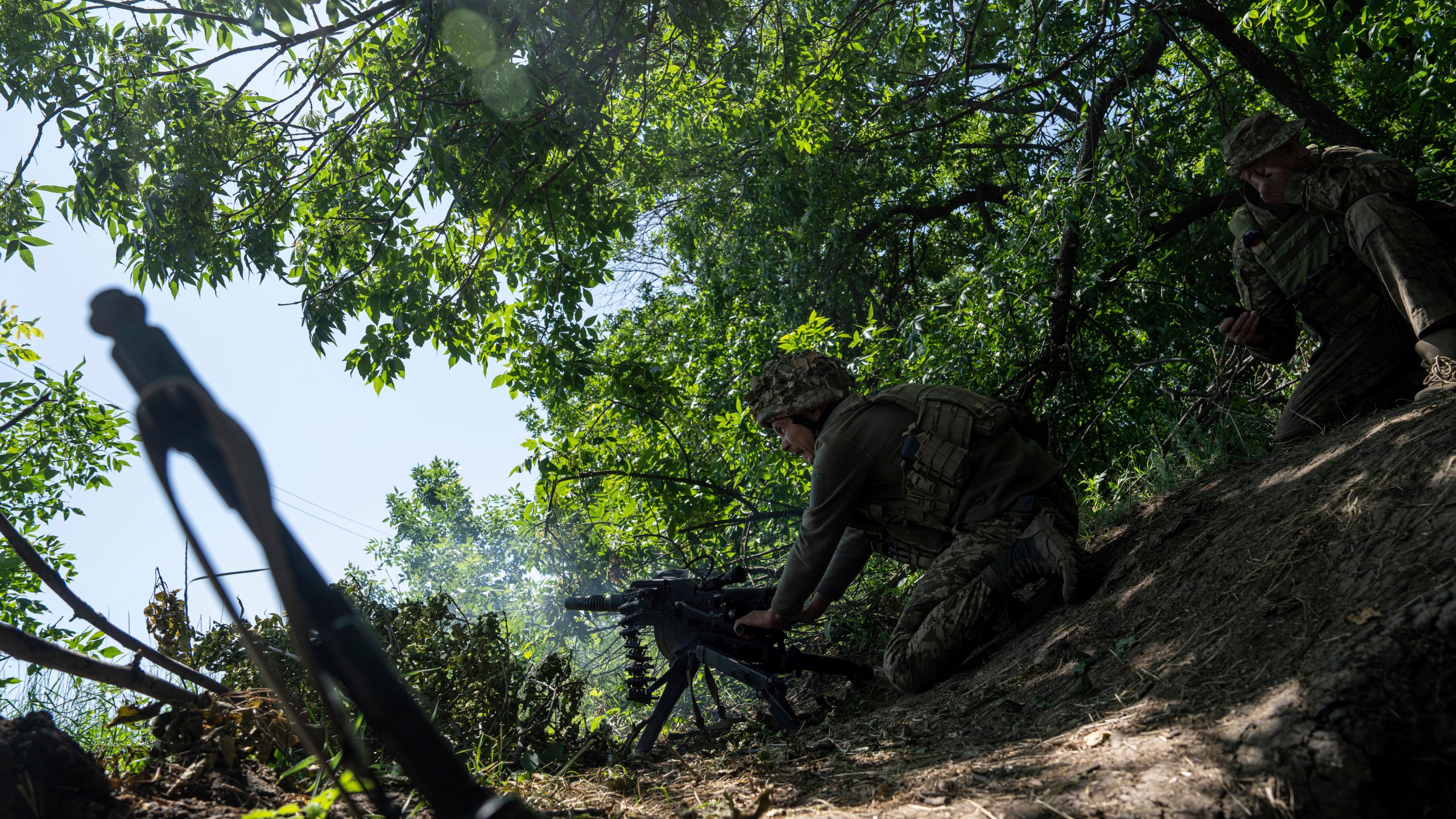 FILE - A Ukrainian marine of 35th brigade fires by automatic grenade launcher AGS-17 towards Russian positions on the outskirts of Avdiivka, Ukraine, on June 19, 2023. Ukrainian troops are under intense pressure from a determined Russian effort to storm the strategically important eastern Ukraine city of Avdiivka, officials say. Kyiv’s army is struggling with ammunition shortages as the Kremlin’s forces pursue a battlefield triumph around the two-year anniversary of Moscow’s full-scale invasion and ahead of a March presidential election in Russia. (AP Photo/Evgeniy Maloletka, File)