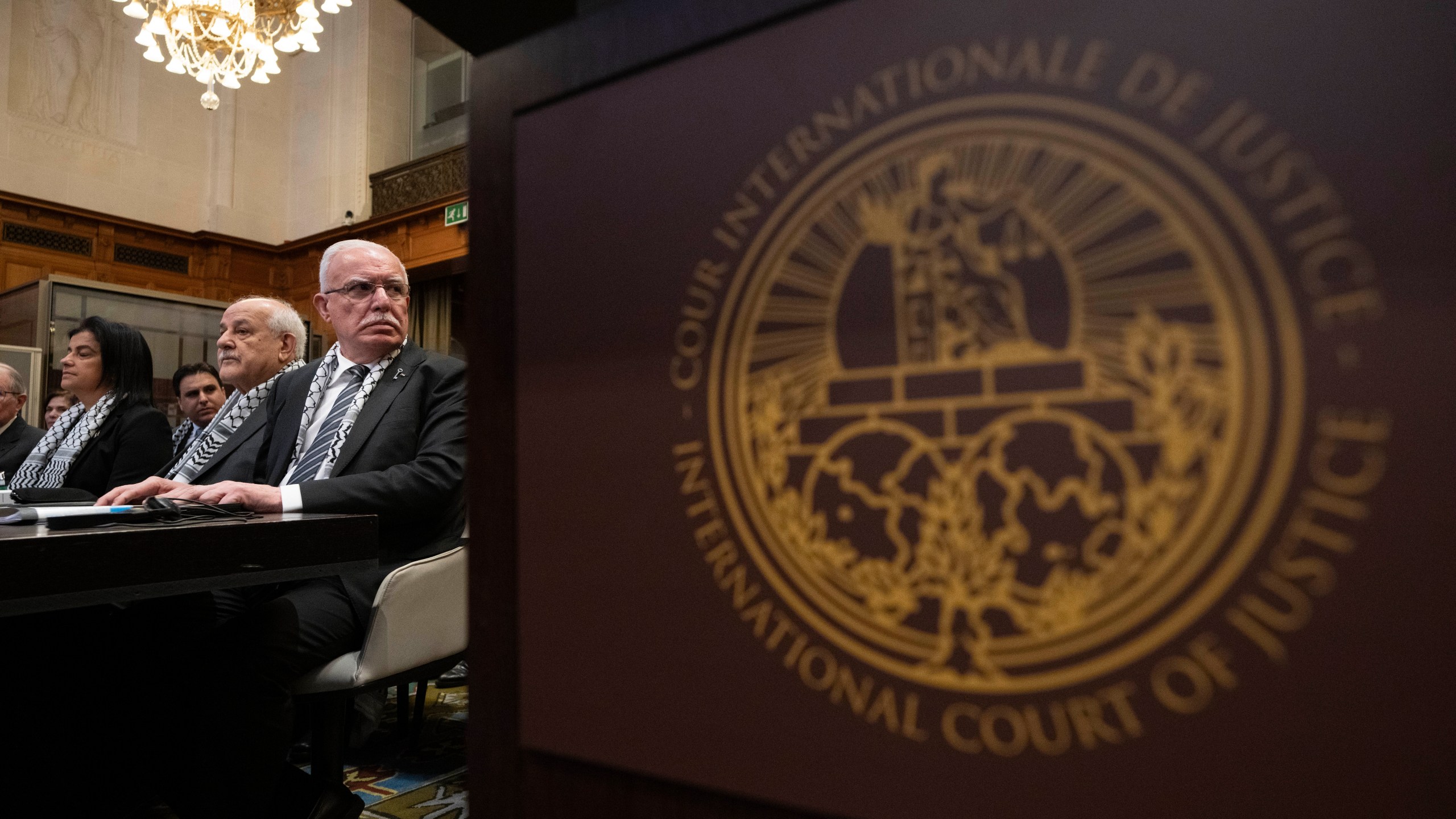 The Minister of Foreign Affairs of the Palestinian National Authority, Riyad Al-Maliki, third left, waits for the United Nations' highest court to open historic hearings in The Hague, Netherlands, Monday, Feb. 19, 2024. Six days of hearings opened Monday at the top United Nations court into the legality of Israel’s 57-year occupation of lands sought for a Palestinian state. Foreign Affairs Minister Riyad al-Maliki is expected to open the presentation by Palestinian representatives at the International Court of Justice that is scheduled to last all morning .(AP Photo/Peter Dejong)