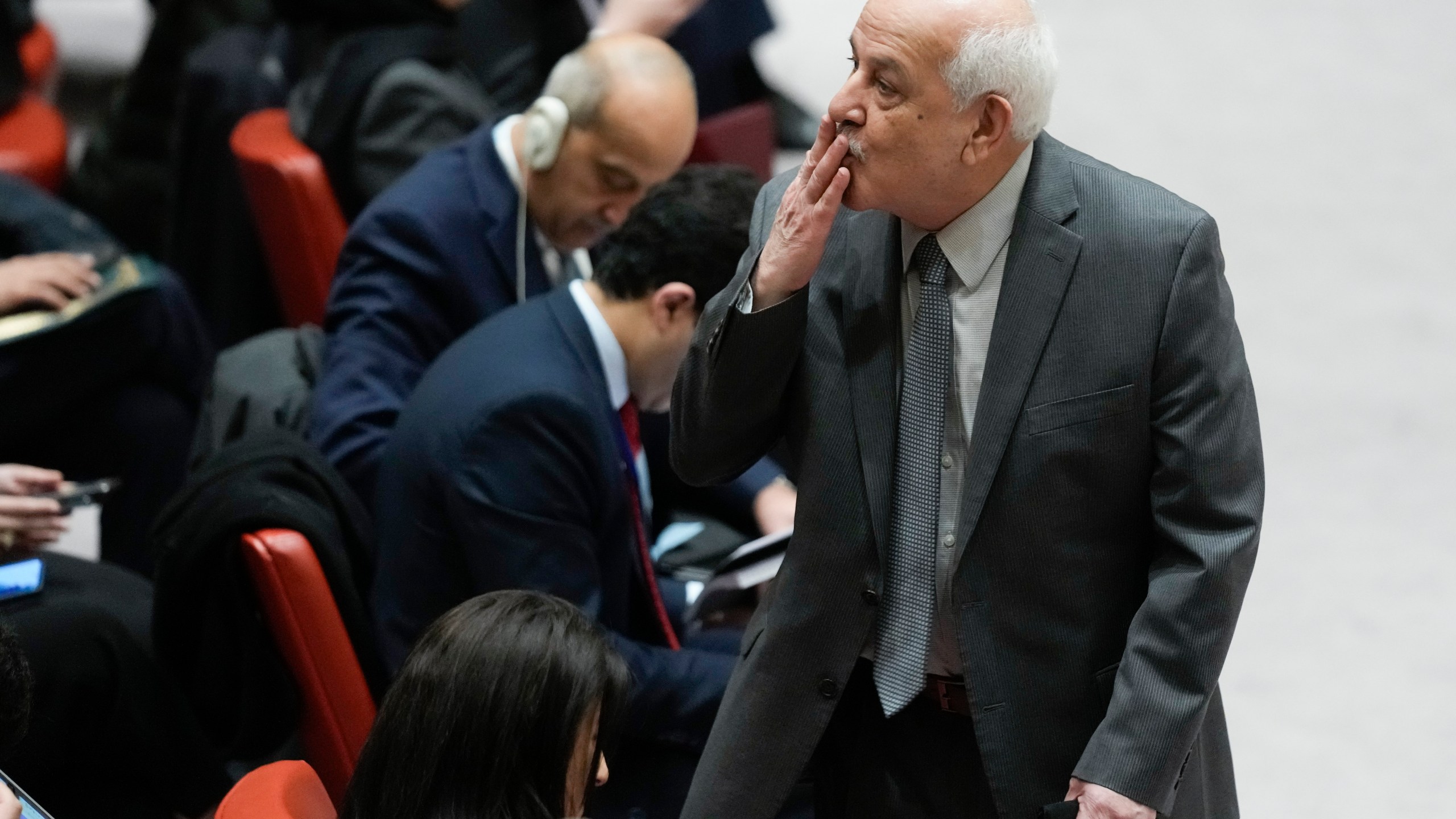 Riyad Mansour, Palestinian Ambassador to the United Nations, blows a kiss to someone before the start of Security Council meeting at United Nations headquarters, Tuesday, Feb. 20, 2024. (AP Photo/Seth Wenig)