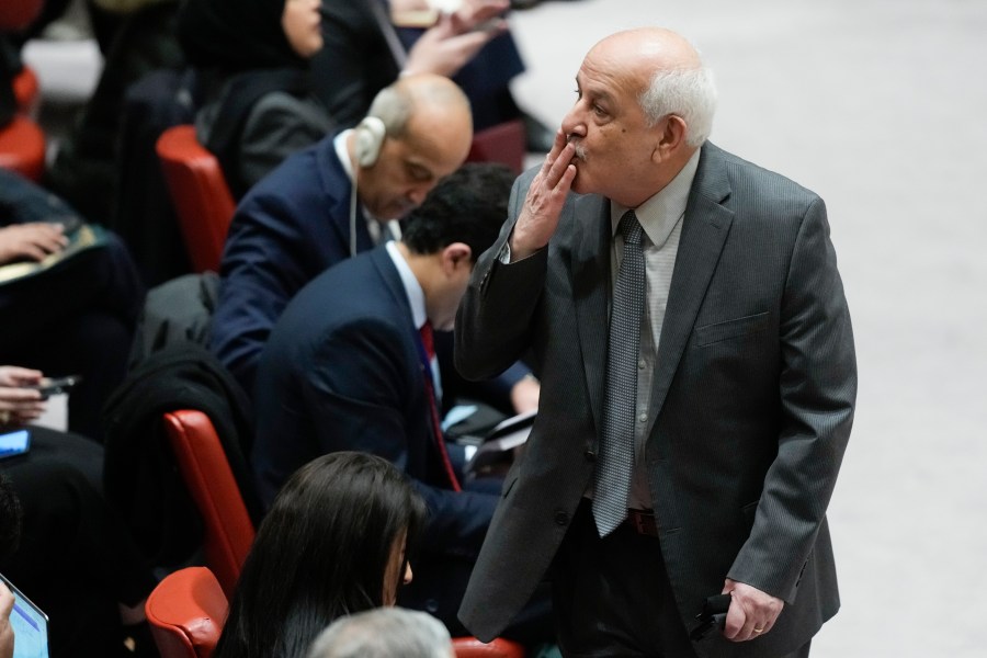 Riyad Mansour, Palestinian Ambassador to the United Nations, blows a kiss to someone before the start of Security Council meeting at United Nations headquarters, Tuesday, Feb. 20, 2024. (AP Photo/Seth Wenig)