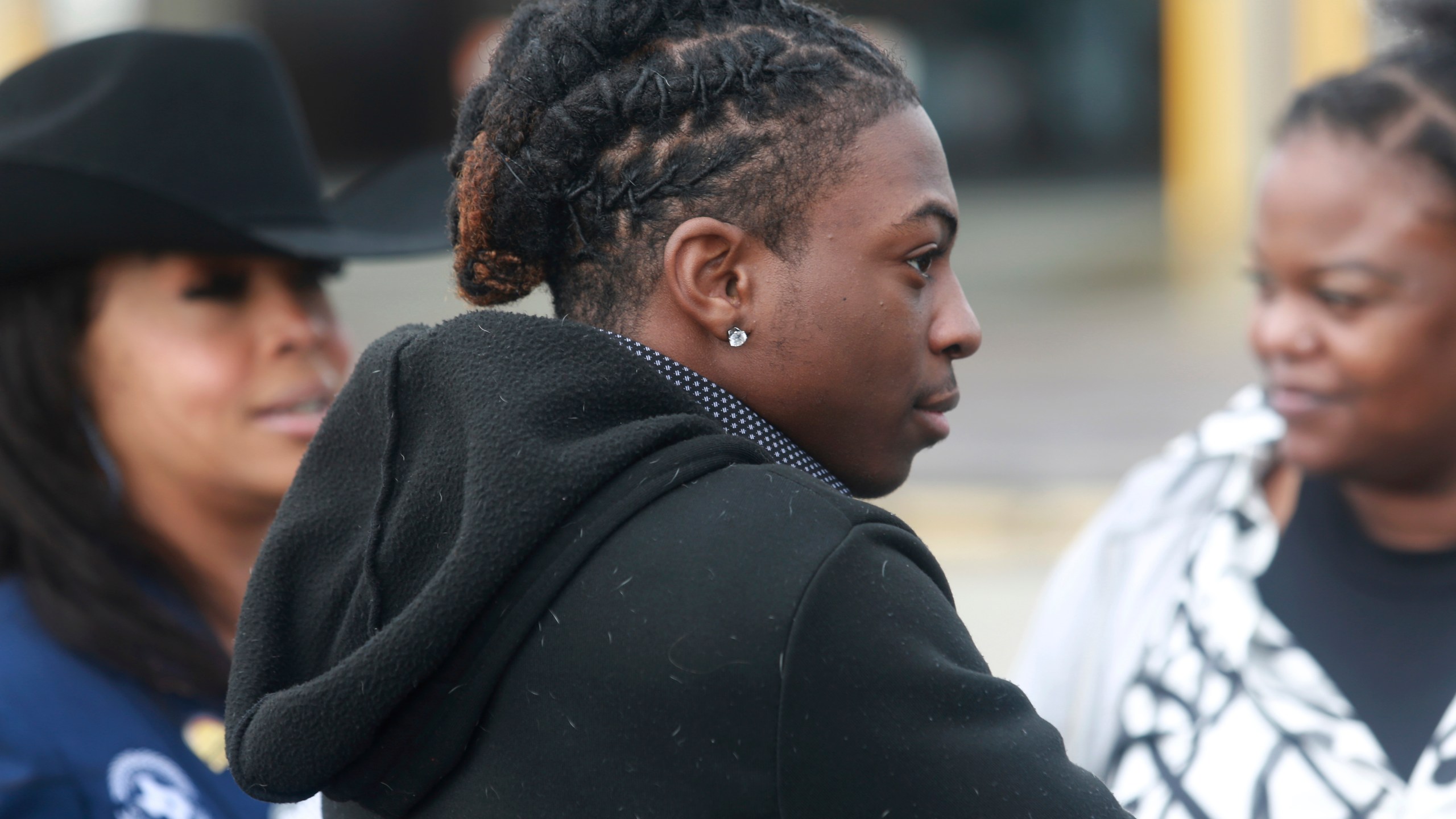 FILE - Darryl George, an 18-year-old high school junior, stands outside a courthouse in Anahuac, Texas, on Wednesday, Jan. 24, 2024, following a court hearing over whether his Houston-area school district can continue to punish him for refusing to change his hairstyle. For as long as schools have policed hairstyles as part of their dress codes, some students have seen the rules as attempts to deny their cultural and religious identities. To school administrators, strict dress codes can be tools for promoting uniformity and discipline. (AP Photo/Lekan Oyekanmi, File)