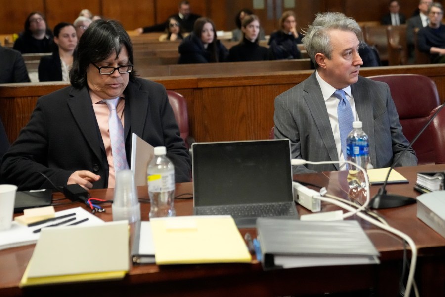 Memorabilia seller Edward Kosinski, left, and former Rock & Roll Hall of Fame curator Craig Inciardi are seated in the defendants chair in the supreme court, Wednesday, Feb. 21, 2024, in New York. A criminal case involving handwritten lyrics to the classic rock megahit “Hotel California” and other Eagles favorites went to trial Wednesday in New York, with three men accused of scheming to thwart band co-founder Don Henley’s efforts to reclaim the allegedly ill-gotten documents. (AP Photo/Mary Altaffer)