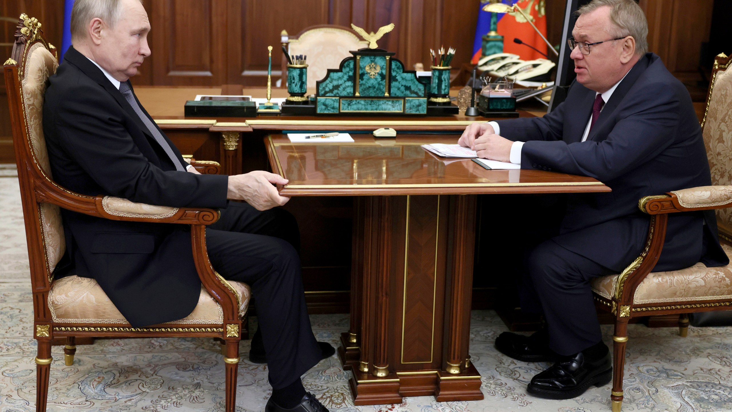 FILE - Russian President Vladimir Putin, left, listens to VTB Bank Chairman Andrei Kostin during their meeting in Moscow, Russia, July 11, 2023. The Justice Department announced Thursday, Feb. 22, 2024, a series of arrests and indictments against Russian businessmen and their facilitators in five separate federal cases meant to send a message to Russian President Vladimir Putin. Among those targeted are sanctioned Russian banker Kostin and two of his U.S.-based facilitators. (Alexander Kazakov, Sputnik, Kremlin Pool Photo via AP, File)