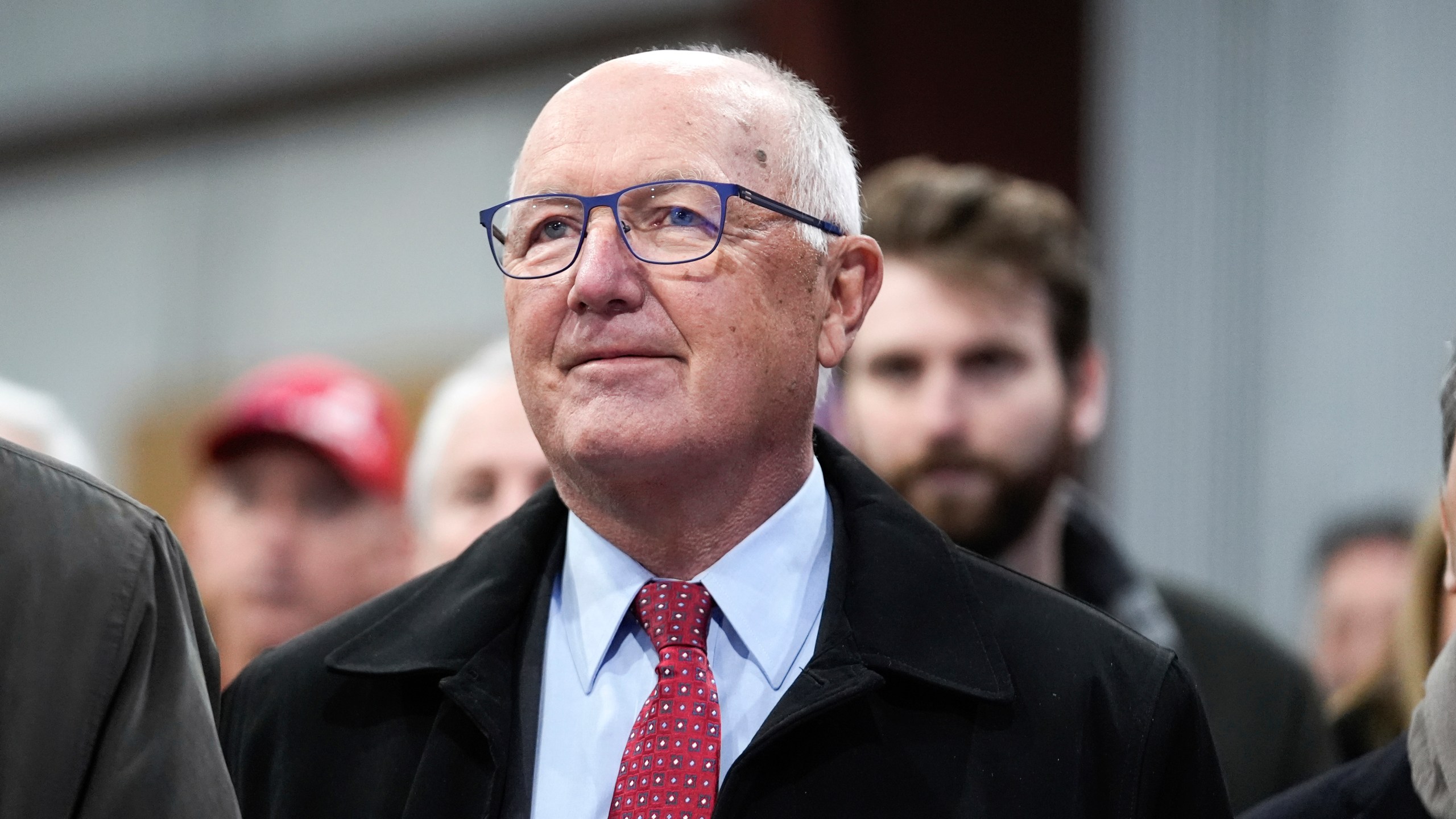 FILE - Michigan Republican Party chair Pete Hoekstra listens to Republican presidential candidate former President Donald Trump at a campaign rally in Waterford Township, Mich., Saturday, Feb. 17, 2024. Michigan Republicans are planning dueling presidential nominating conventions that will take place March 2, even though the national Republican Party said members properly removed former chair Kristina Karamo and recognized former Congressman Hoekstra as the party's new chair. Hoekstra announced Tuesday, Feb. 20, that he would hold a presidential nominating convention in Grand Rapids on the same day Karamo and her backers plan to hold one in Detroit. (AP Photo/Paul Sancya, File)