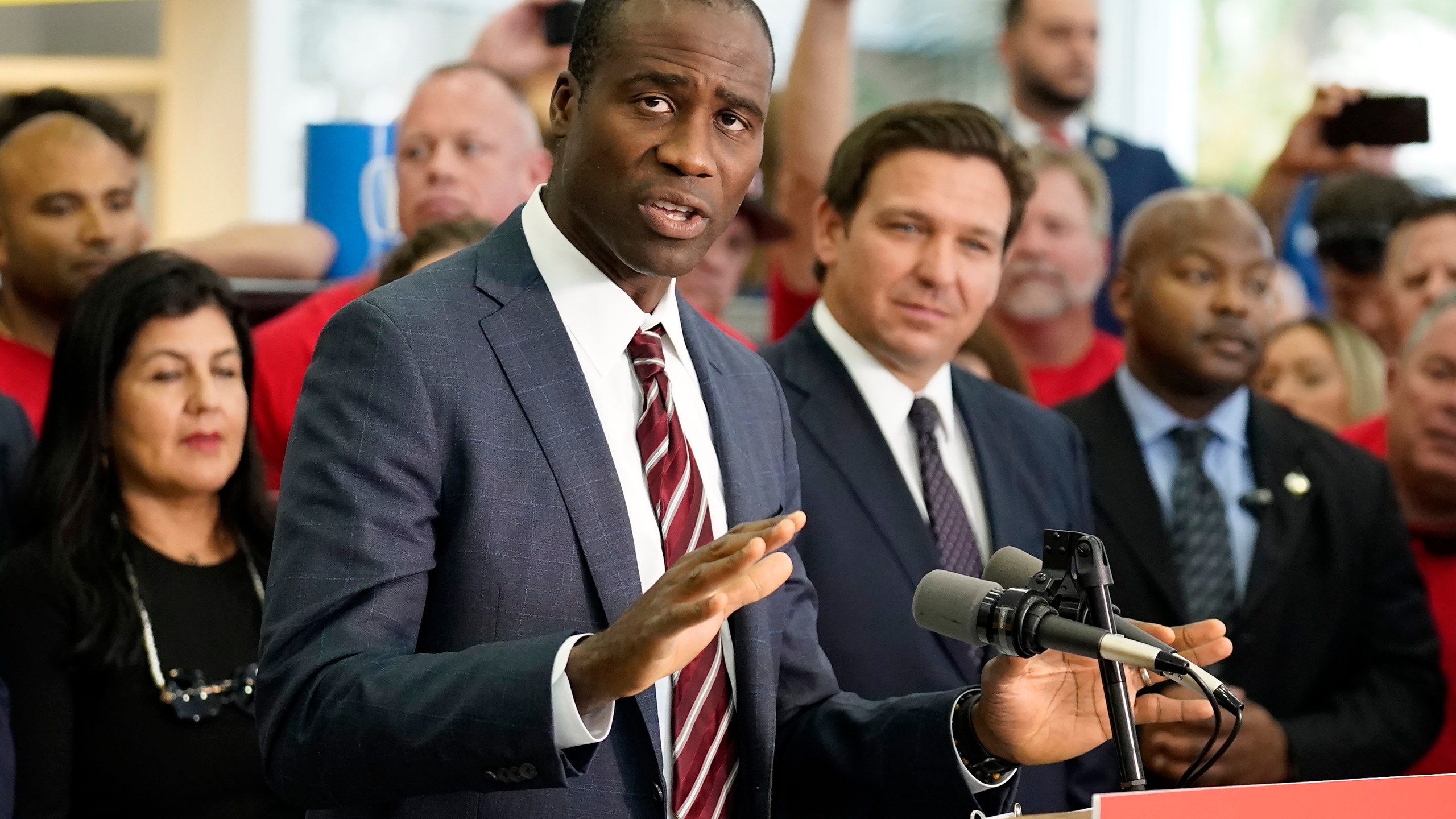 FILE - Florida Surgeon General Dr. Joseph Ladapo gestures as speaks to supporters and members of the media before a bill signing by Gov. Ron DeSantis Thursday, Nov. 18, 2021, in Brandon, Fla. Florida's controversial surgeon general is drawing criticism for his handling of an elementary school's measles outbreak, telling parents of unvaccinated children it is their choice whether their student attends class — a direct contravention of federal guidelines. (AP Photo/Chris O'Meara, File)