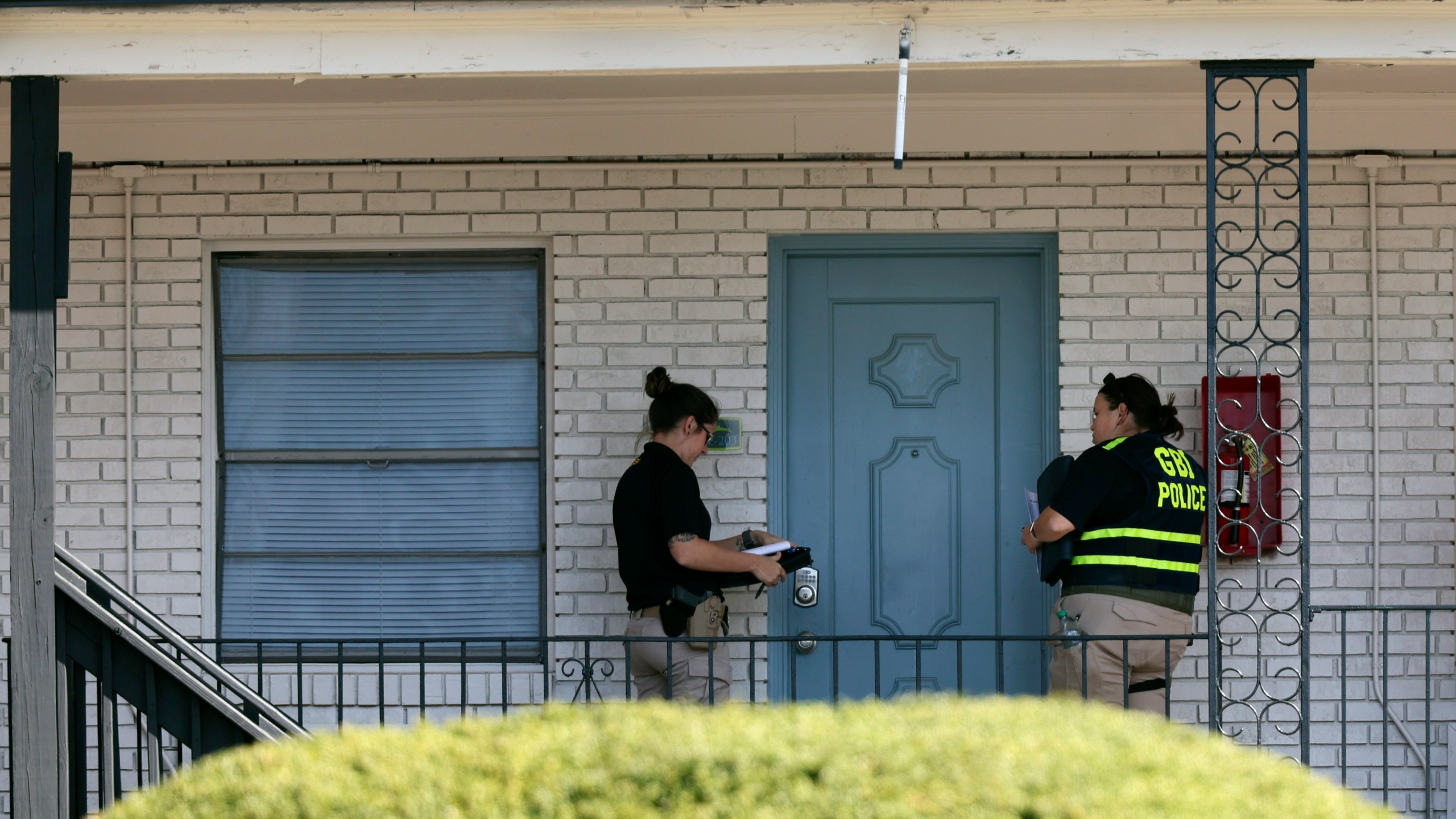 Georgia Bureau of Investigation (GBI) officers go door to door at the Cielo Azulak Apartments, Friday, Feb. 23, 2024, in Athens, Ga. Police said Friday that they are questioning a “person of interest” in the death of a nursing student whose body was found on the University of Georgia campus after not returning from a run.(Jason Getz/Atlanta Journal-Constitution via AP)