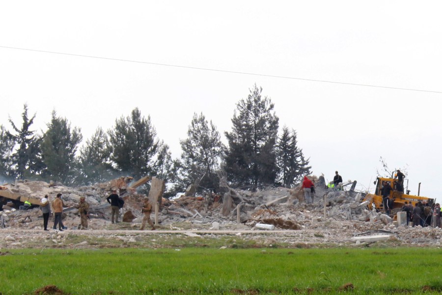 Lebanese soldiers and civil defence workers gather near a destroyed warehouse which was attacked by Israeli airstrikes, on the outskirts of the Hezbollah stronghold village of Buday, near Baalbek town, east Lebanon, Monday, Feb. 26, 2024. The Israeli military says its air force struck targets of the militant Hezbollah group "deep inside Lebanon," where residents reported explosions near the northeastern city of Baalbek. (AP Photo)