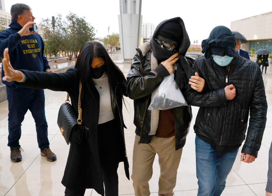 FILE - Alexander Smirnov, second from right, leaves the courthouse on Feb. 20, 2024, in Las Vegas. Smirnov, a former FBI informant charged with lying about a multimillion-dollar bribery scheme involving President Joe Biden’s family, will appear in a California federal court on Monday, Feb. 26, as a judge considers whether he must remain behind bars while he awaits trial. Special counsel David Weiss’ office is pressing Judge Otis Wright II to keep Smirnov in jail, arguing the man who claims to have ties to Russian intelligence is likely to flee the country. (Bizuayehu Tesfaye/Las Vegas Review-Journal via AP, File)