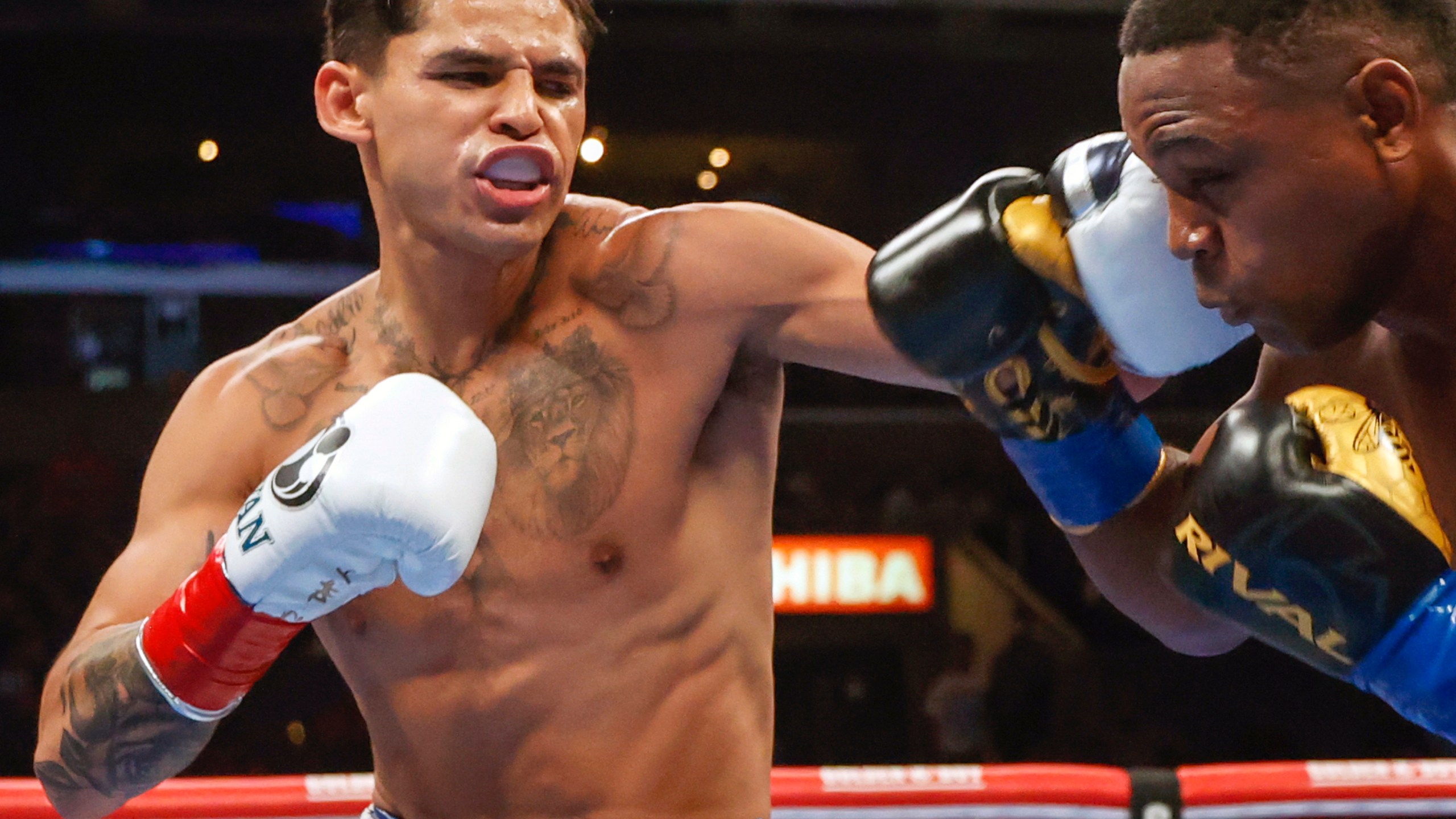 FILE - Ryan Garcia, left, hits Javier Fortuna, right, during a lightweight boxing bout July 16, 2022, in Los Angeles. The fighters seemed just as surprised as fight fans when it was announced that Garcia and Devin Haney, two Californians, would have their April 20, 2024, title fight in New York. But Oscar De La Hoya, Garcia’s promoter, says bringing the event to Brooklyn is common sense. (AP Photo/Ringo H.W. Chiu, File)