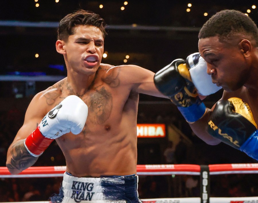 FILE - Ryan Garcia, left, hits Javier Fortuna, right, during a lightweight boxing bout July 16, 2022, in Los Angeles. The fighters seemed just as surprised as fight fans when it was announced that Garcia and Devin Haney, two Californians, would have their April 20, 2024, title fight in New York. But Oscar De La Hoya, Garcia’s promoter, says bringing the event to Brooklyn is common sense. (AP Photo/Ringo H.W. Chiu, File)