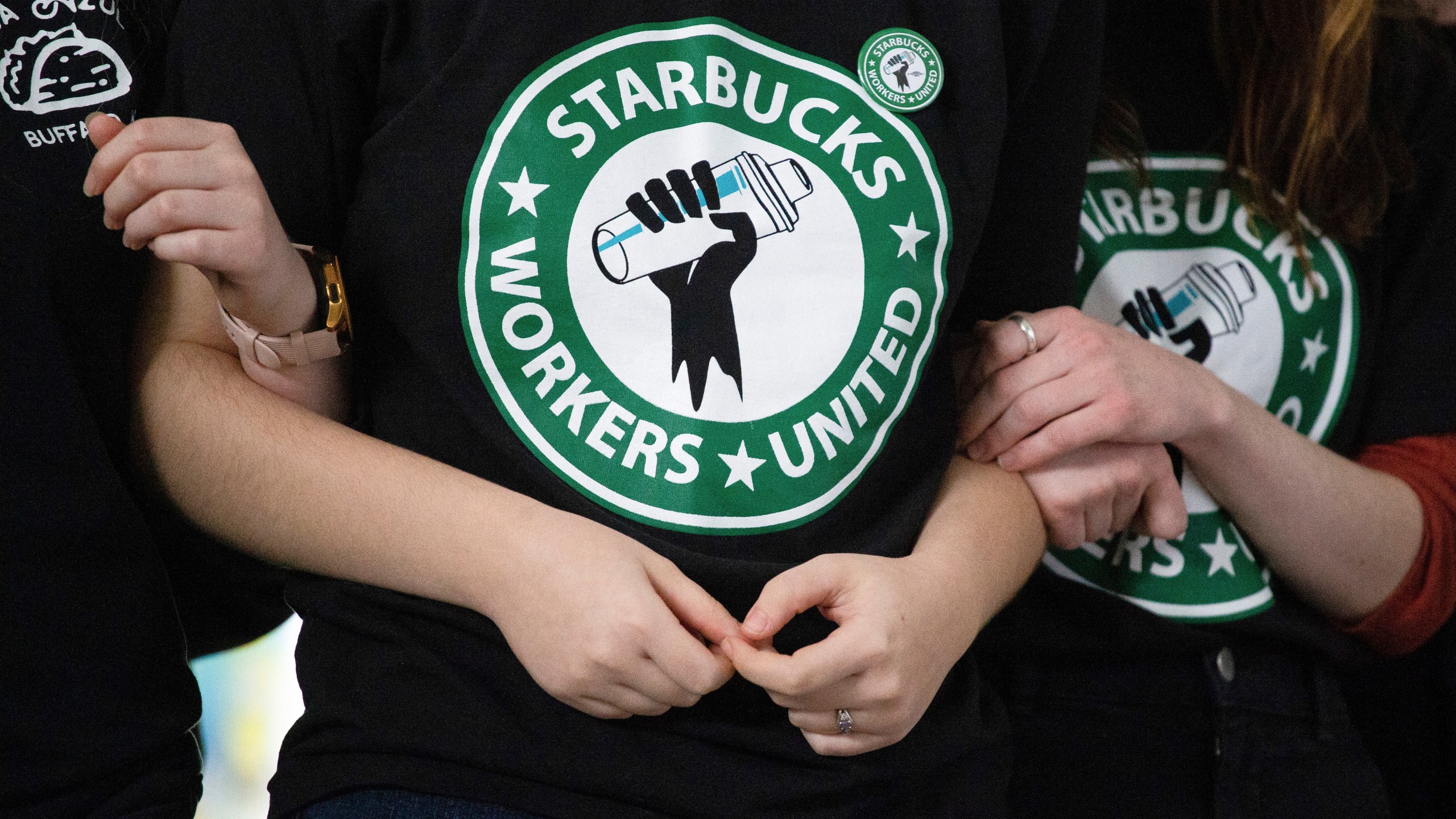 FILE - Starbucks employees and supporters link arms during a union election watch party Dec. 9, 2021, in Buffalo, N.Y. Starbucks and the union organizing its U.S. workers said Tuesday, Feb. 27, 2024, they have agreed to begin talks with the aim of reaching labor agreements. (AP Photo/Joshua Bessex, File)