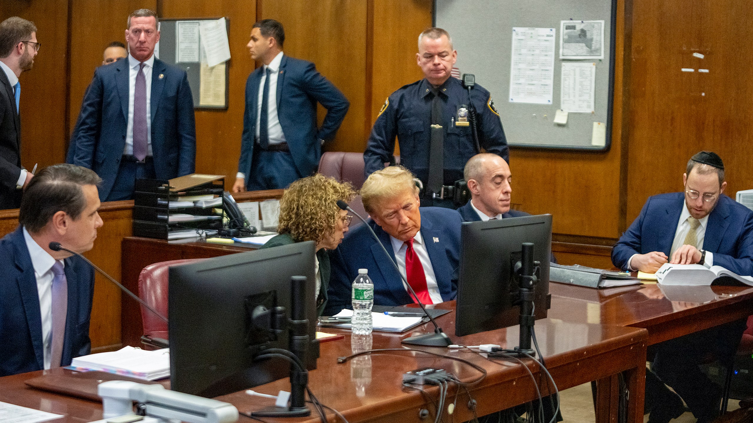 Former President Donald Trump awaits the start of a hearing in New York Criminal Court, Thursday, Jan. 15, 2024, in New York. A New York judge says former President Donald Trump's hush-money trial will go ahead as scheduled with jury selection starting on March 25. (Steven Hirsch/Pool Photo via AP)