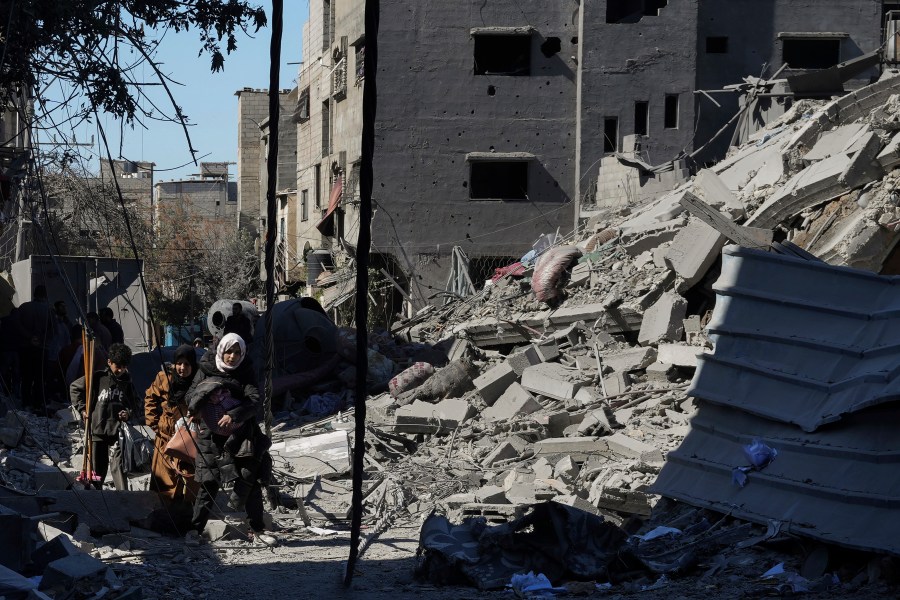 Palestinians inspect the rubble of destroyed buildings after an Israeli airstrike in Nusseirat refugee camp, central Gaza Strip, on Thursday, Feb. 29, 2024. (AP Photo/Adel Hana)