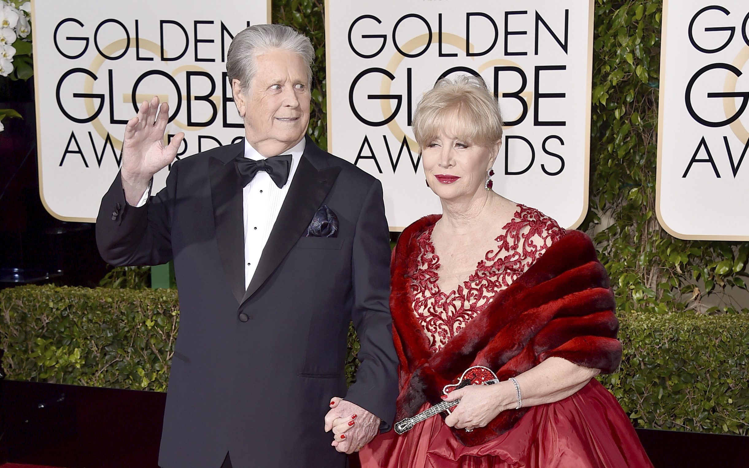 FILE - Brian Wilson, left, and his wife Melinda Ledbetter arrive at the 73rd annual Golden Globe Awards in Beverly Hills, Calif., on Jan. 10, 2016. The management team of the Beach Boys co-founder has filed papers to put him in a conservatorship. The court filing says Wilson needs someone to oversee his daily life and medical decisions because of the recent death of his wife. (Photo by Jordan Strauss/Invision/AP, File)