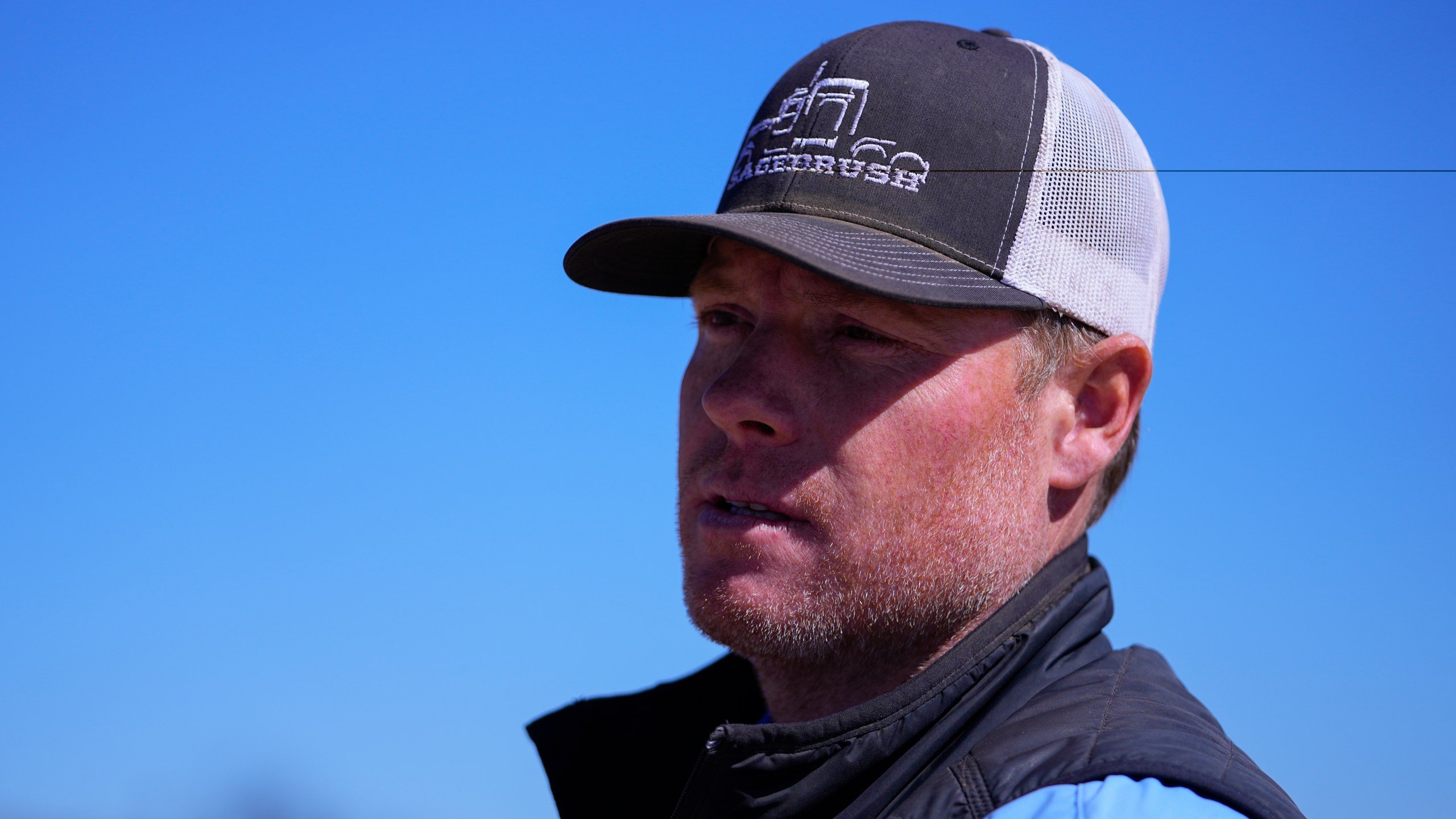 Chance Bowers looks on as his dead cattle is collected after he lost more than 200 head of cattle in the Smokehouse Creek Fire, Friday, March 1, 2024, in Skellytown, Texas. The wildfire, which started Monday, has left behind a charred landscape of scorched prairie, dead cattle and burned-out homes in the Texas Panhandle. (AP Photo/Julio Cortez)