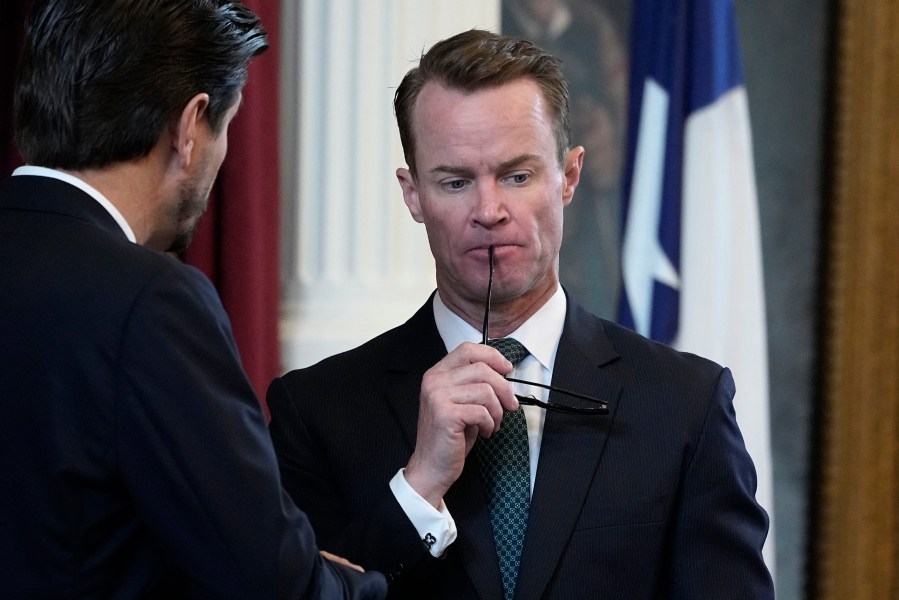 FILE - Texas House Speaker Dade Phelan, right, talks with a fellow lawmaker in the House Chamber at the Texas Capitol in Austin, Texas, Friday, May 26, 2023. Texas Attorney General Ken Paxton beat impeachment and now he wants political revenge, on Super Tuesday. His chief target is Phelan. (AP Photo/Eric Gay, File)