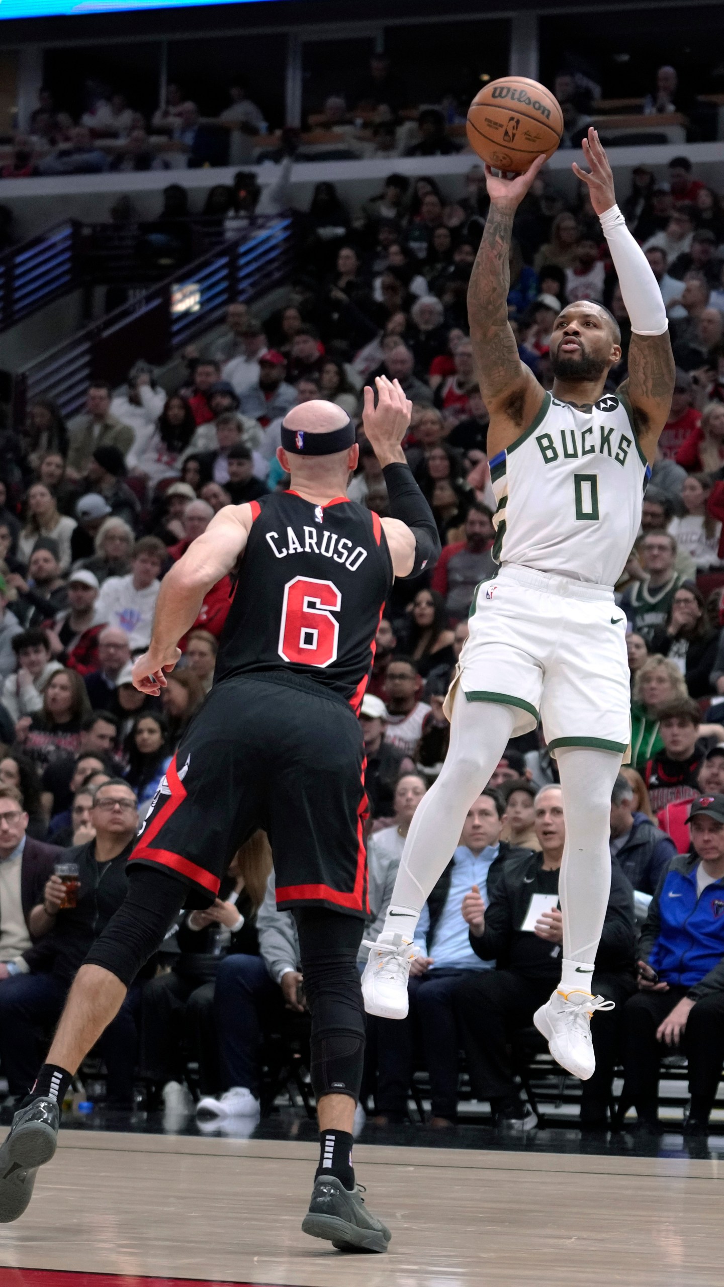 Milwaukee Bucks' Damian Lillard shoots over Chicago Bulls' Alex Caruso during the first half of an NBA basketball game Friday, March 1, 2024, in Chicago. (AP Photo/Charles Rex Arbogast)
